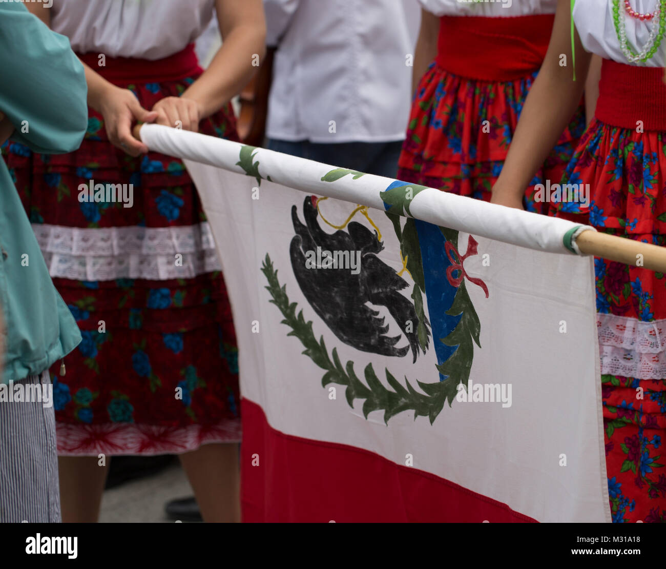 Rolling up a mexican flag Stock Photo Alamy