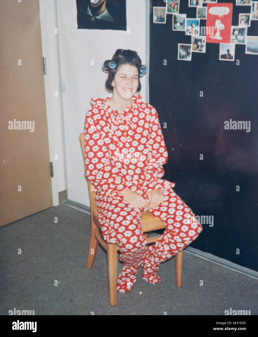 Teenager with Rollers in her Hair Wearing One-Piece Footed Pajamas, USA Stock Photo