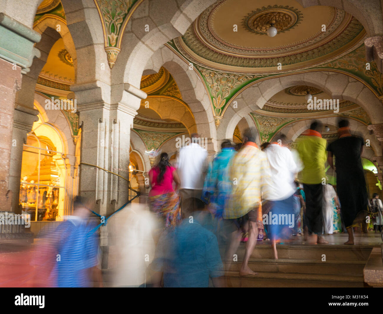 MYSORE, INDIA - January 11 2018: People walk in the Colorful ornate interior halls of royal Mysore Palace, Karnataka, India Stock Photo