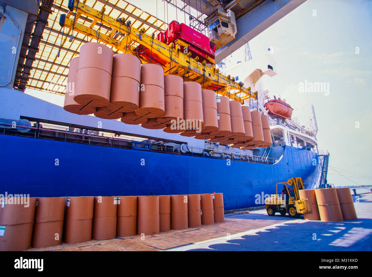 Ship cargo hold loading and unloading of large rolls of newsprint paper ...