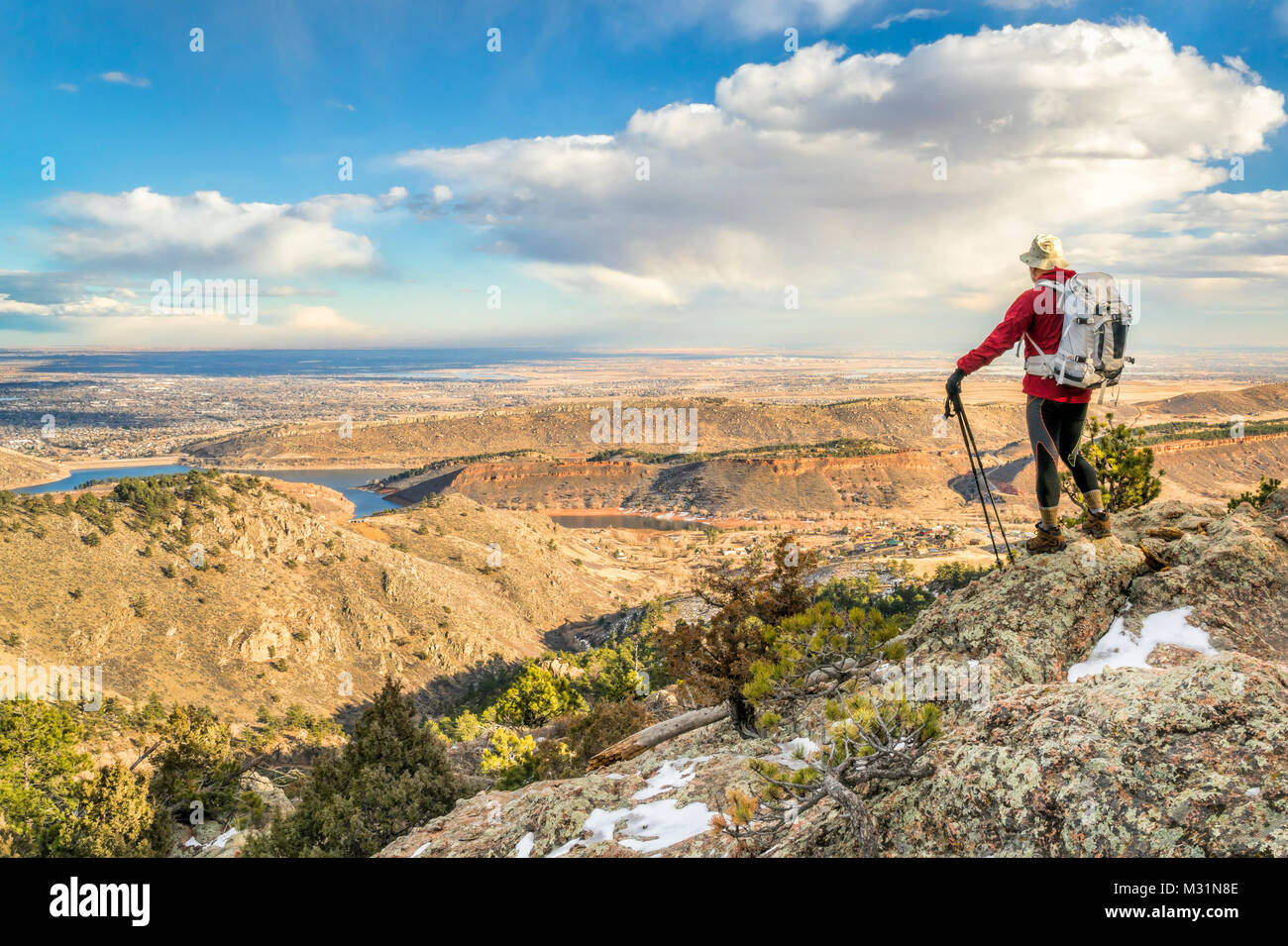 a backpacker on a mountain ridge overlooking Colorado foothills and plains - Horsetooth Rock trail above Fort Collins Stock Photo