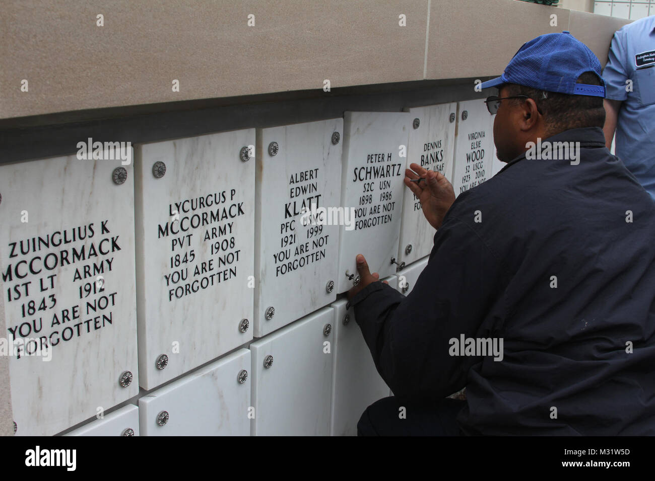 ARLINGTON, Va. Arlington National Cemetery workers screw niche covers