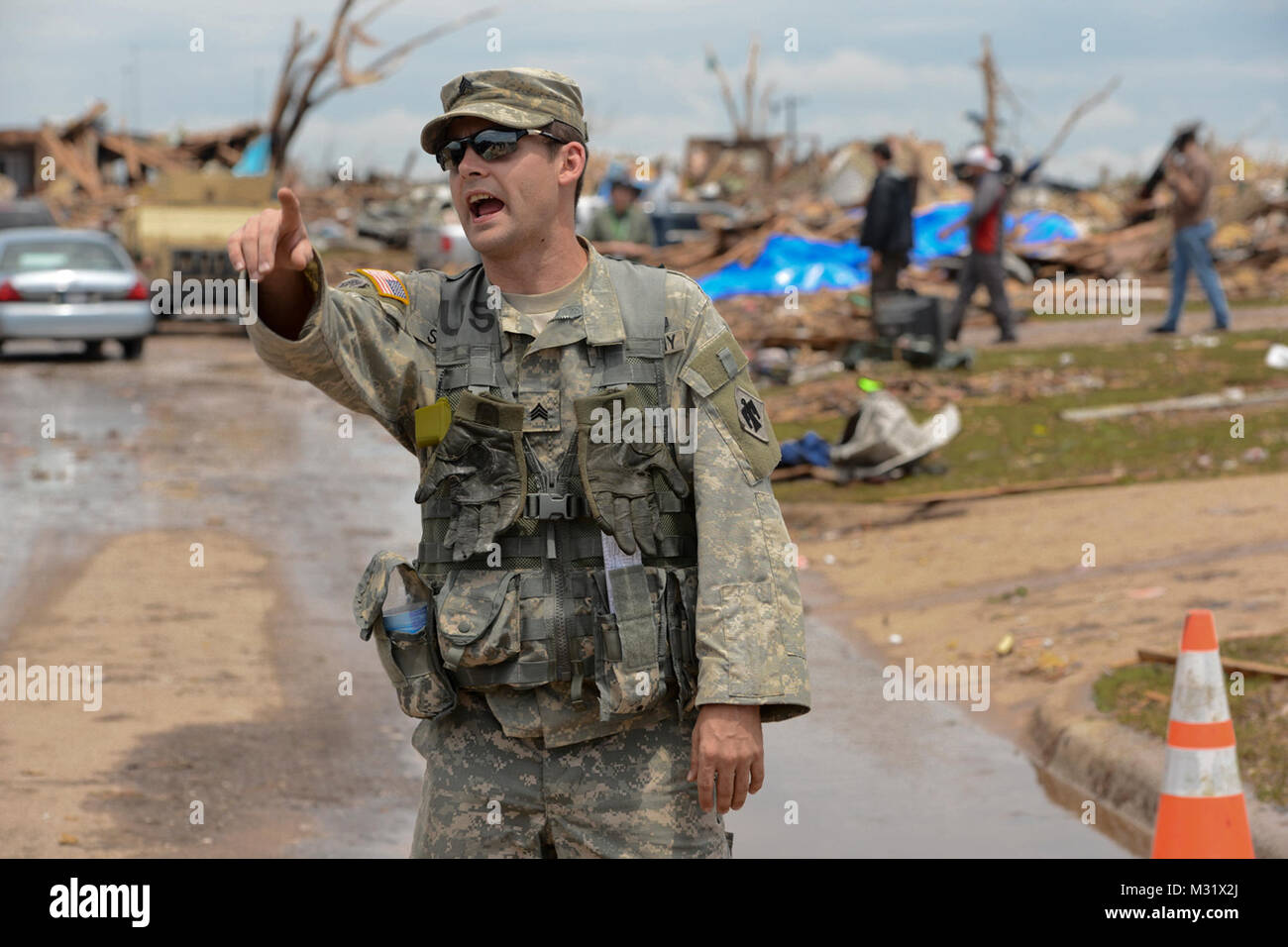 Oklahoma Army National Guardsman, Sgt Joseph Sisco with Headquarters Company, 1st Battalion, 179th Infantry, 45th Infantry Brigade Combat Team, Gives direction to members of his communicty presence patrol team. Community presence patrols provided assistance to residents of Moore, Okla., who were affected by the May 20th, 2013,  F5 tornado which tore through the community, leaving a path of devistation up to a mile wide and 18 miles long.  (U.S. Air National Guard photo by Master Sgt. Mark Moore/Released) Community Presence Patrols 001 by Oklahoma National Guard Stock Photo