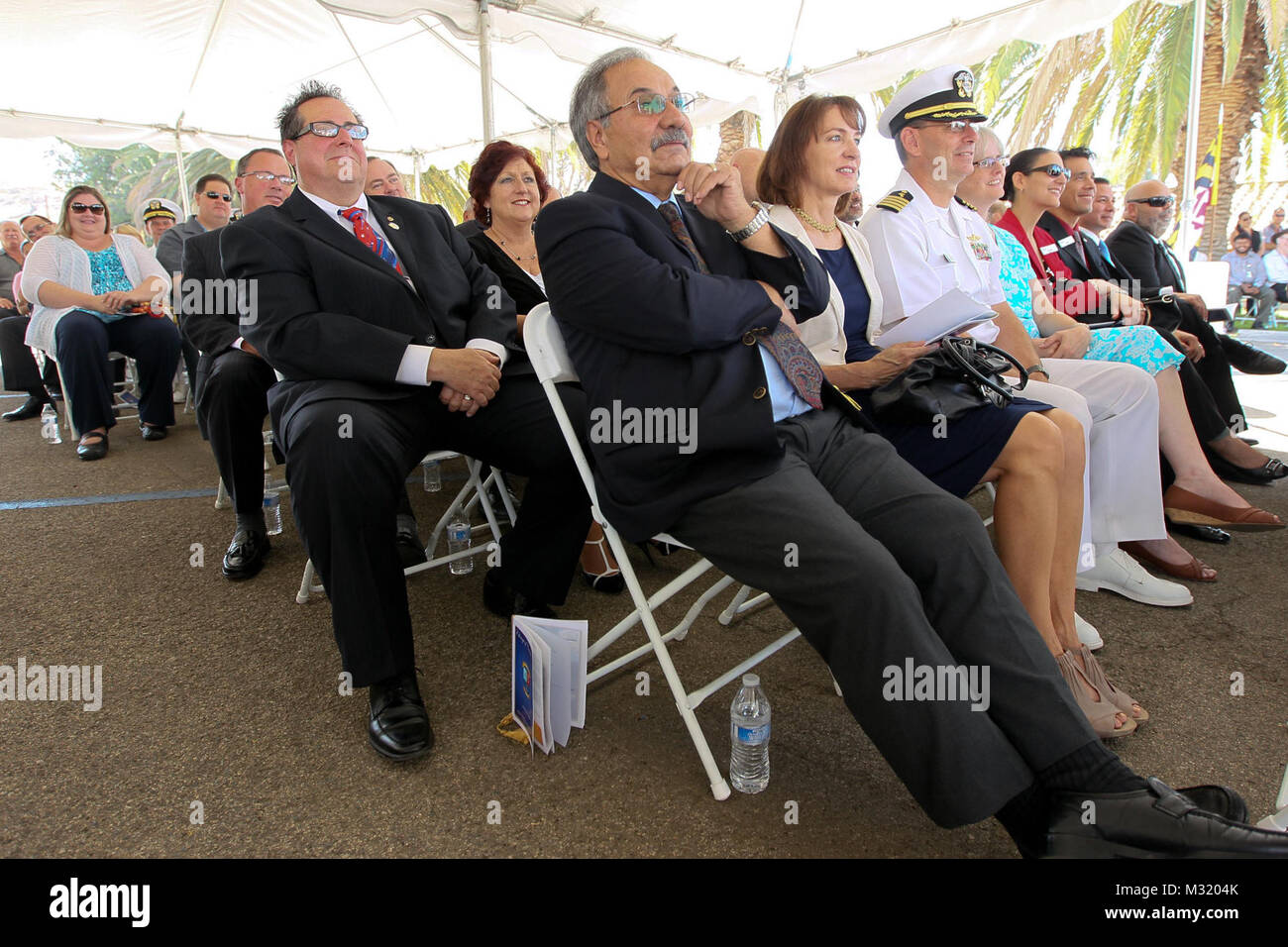 140801-N-HW977-252 NORCO, Calif. (Aug. 1, 2014) Dignitaries, including Reza Abbaschian, University of California , Riverside Bourns College of Engineering dean, center right, and Bobby Spiegel president/CEO of Corona Chamber of Commerce, watch Change of Command ceremony at Naval Surface Warfare Center (NSWC), Corona Division, tranferring the reins from Capt. Eric Ver Hage to Capt. (Sel) Steve Murray. In his keynote address Rear Adm. Lawrence Creevy, commander, Naval Surface Warfare Center, remarked Ver Hage's most important qualities were vision, accomplishment and leadership. Creevy's list of Stock Photo