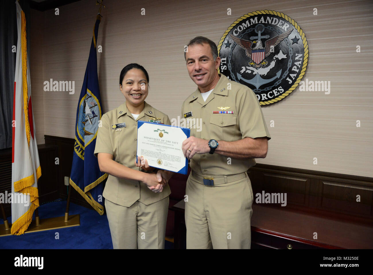 Lt. Cynthia Duke receives the Navy and Marine Corps commendation award medal from Commander, U.S