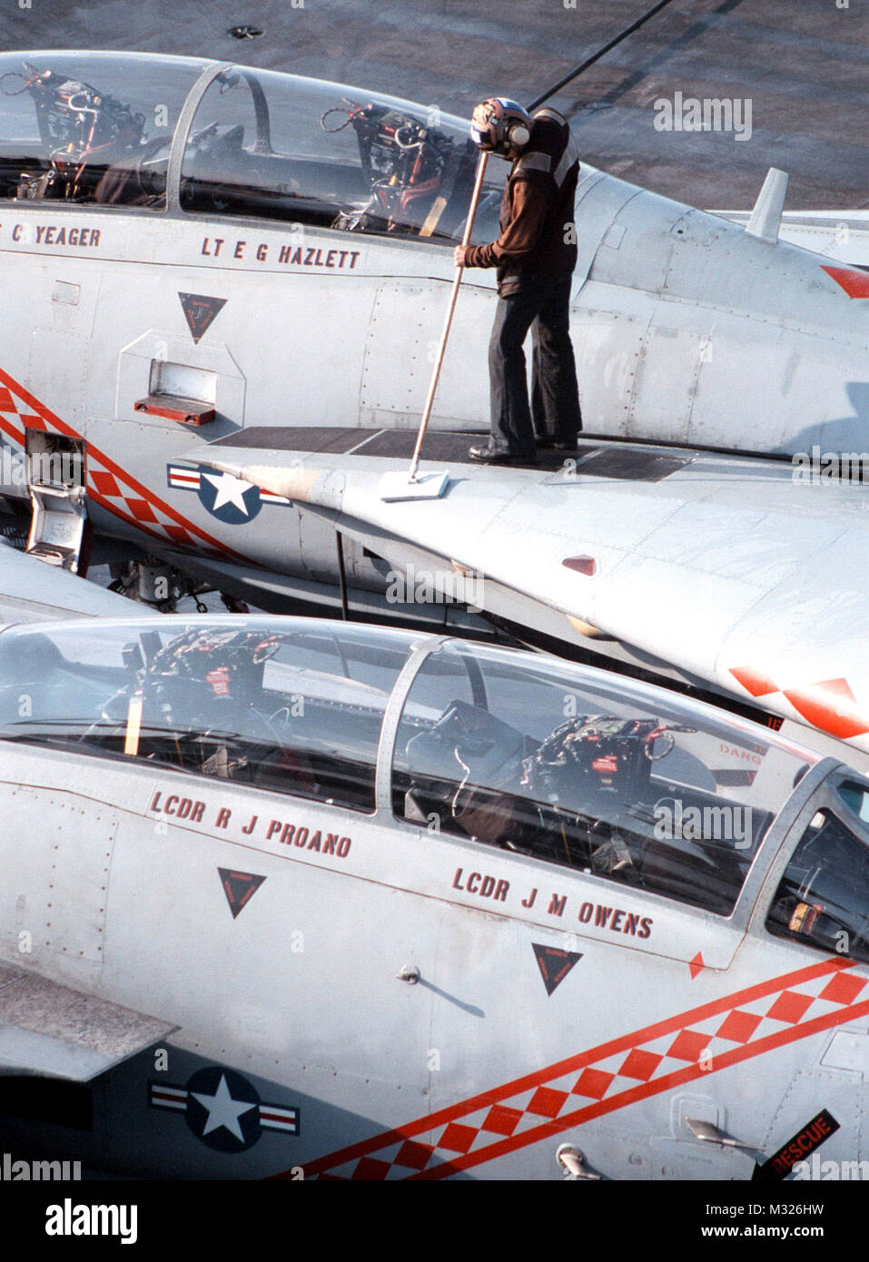 980226-N-0507F-001 Aboard USS George Washington CVN 73 (February 26th, 1998) -- A Plane Captain washes an F-14B ÒTomcatÓ from Fighter Squadron One Zero Two (VF-102) on the flight deck.  George Washington and VF-102 are currently conducting operations in the Persian Gulf.  U.S. Navy photo by PhotographerÕs Mate 3rd Class Brian Fleske (Released) NNP030 by navalsafetycenter Stock Photo