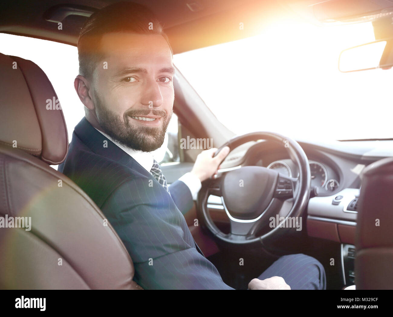 businessman sitting at the wheel of a prestigious car Stock Photo - Alamy