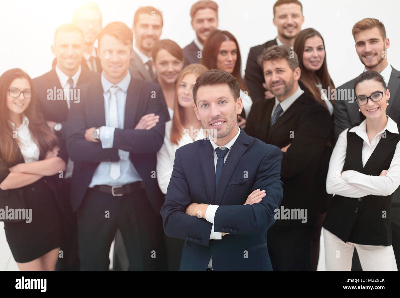 leader standing in front of a large business team Stock Photo - Alamy