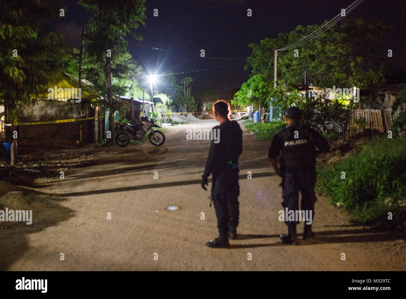 Police officers guard the scene of a shooting in Puerto Morelos, Mexico, on July 11, 2017. One man was killed and another was seriously injured. Local media have called the shooting an assassination. Violence in Mexico spiked in 2017 with more than 12,000 homicides in the first six months, leaving many to question the future of this popular touristic area. Stock Photo