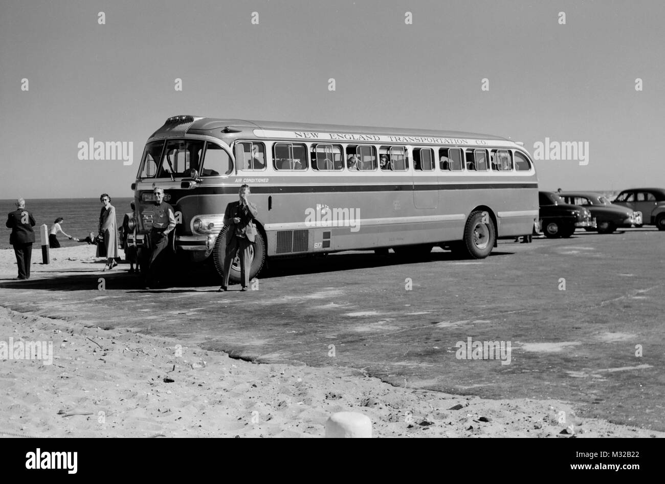 Bus parked on the beach while on a tour of the American East Coast, ca. 1950. Stock Photo