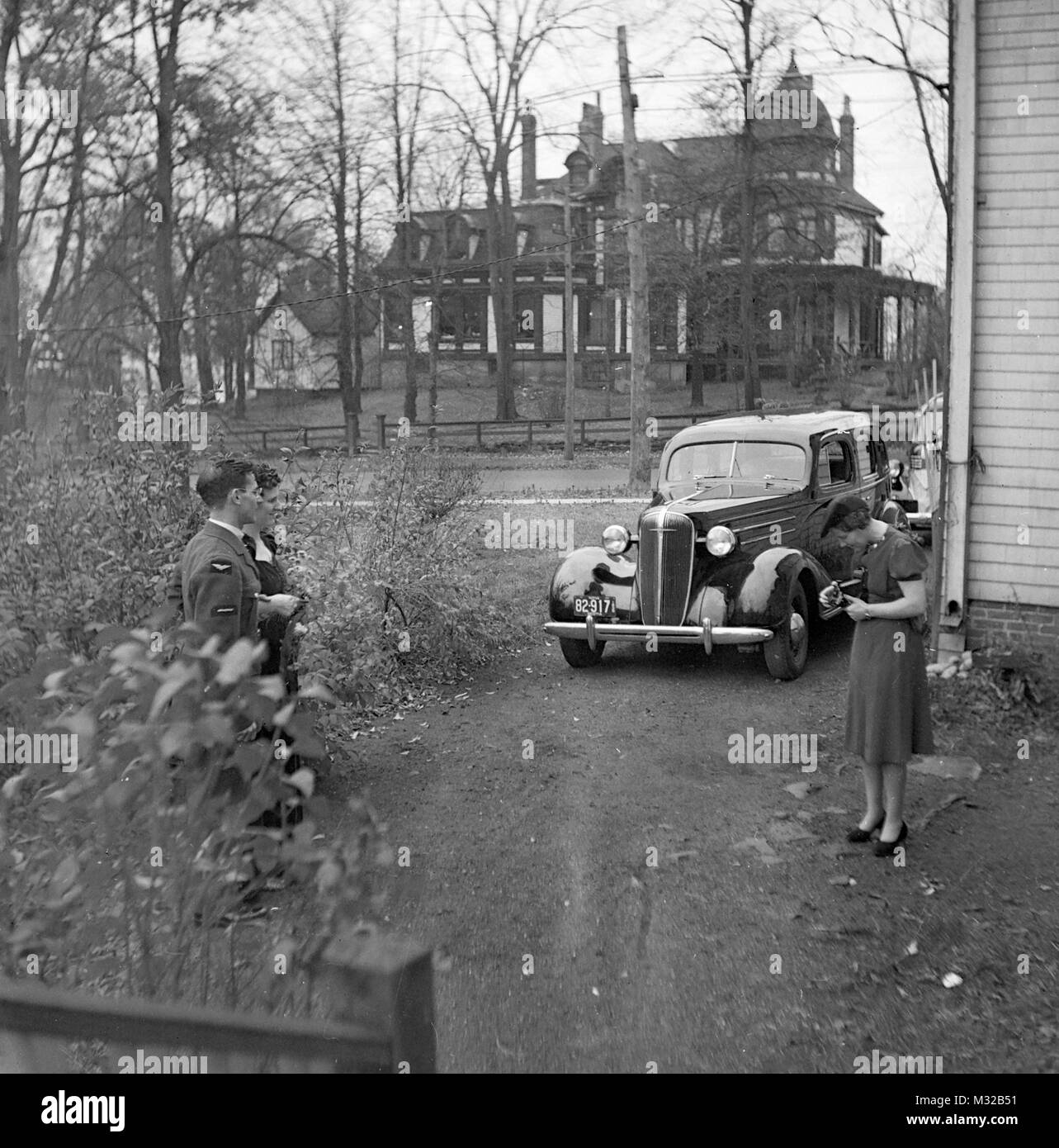 Sericeman and girl have picture taken outside the house in Nova Scotia, ca. 1938. Stock Photo