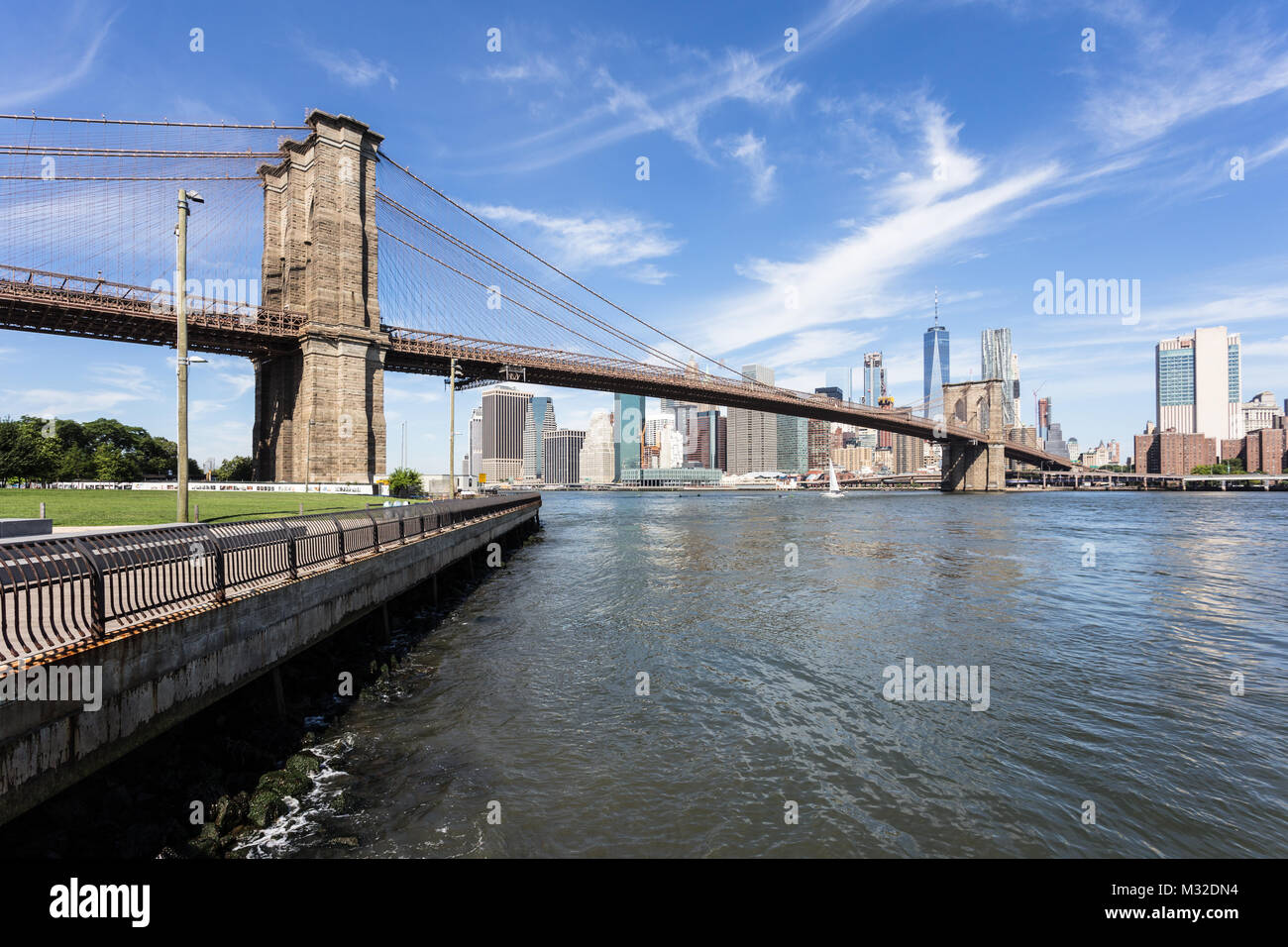 The famous Brooklyn bridge, from DUMBO, with the Manhattan financial district on the other side of the East river in New York city on a sunny day in t Stock Photo