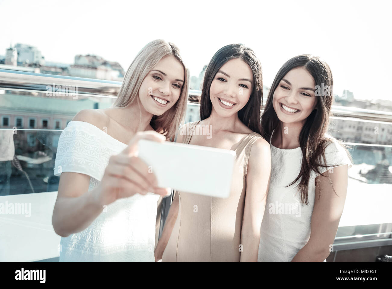 Happy positive woman taking a selfie Stock Photo - Alamy