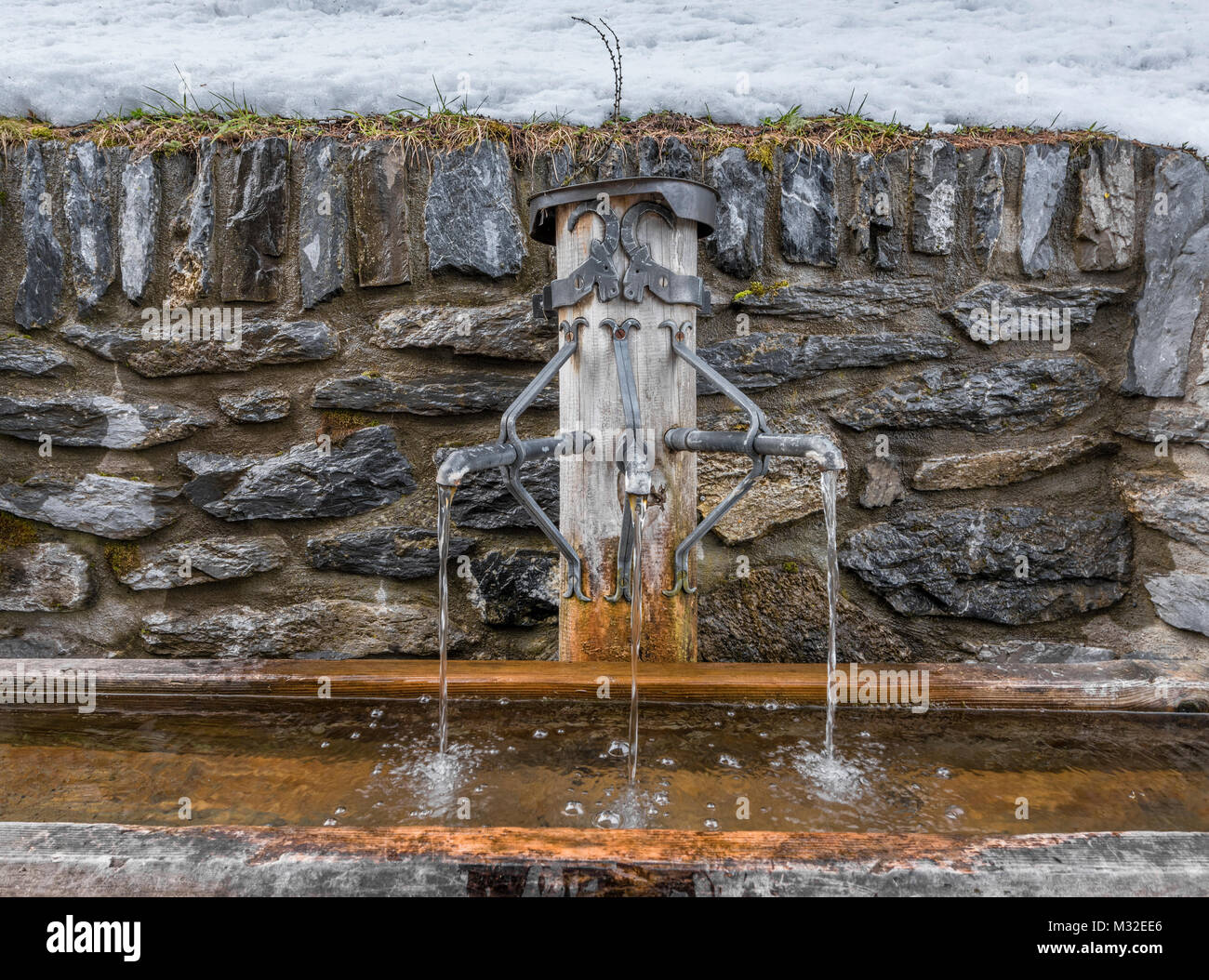 Drinking water tap in alpine village in Switzerland Stock Photo Alamy