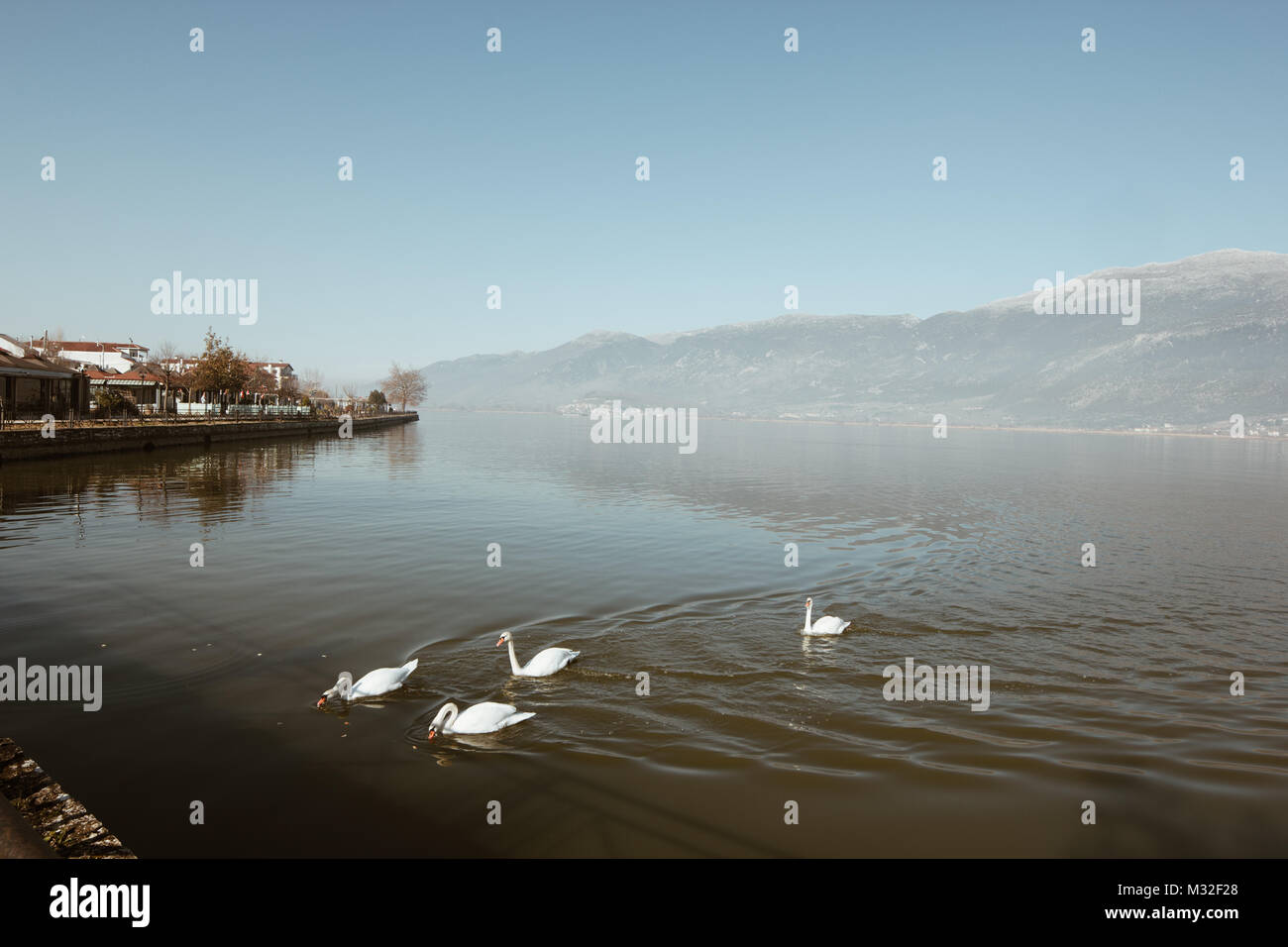 Ioannina lake in Epirus Region, Greece. Artistic panoramic view with natural reflection in the water and fog Stock Photo