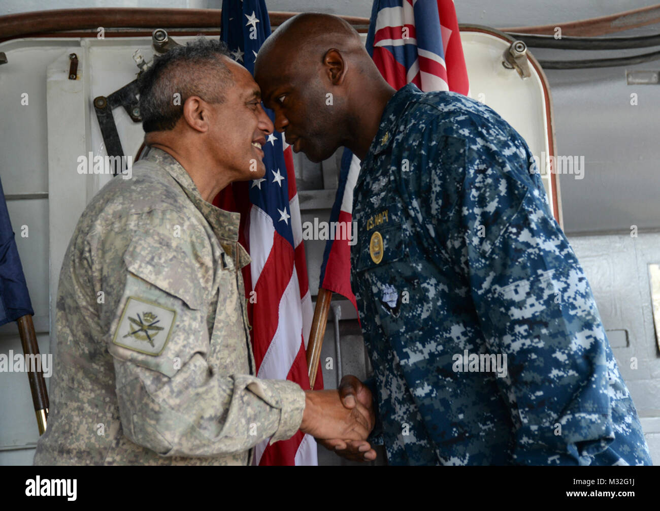 150621-N-GI544-037 PEARL HARBOR (June 21, 2015) New Zealand Defense Force Warrant Officer Class One Danny Broughton, left, and Command Master Chief Mickey Jones, command master chief of the guided missile cruiser USS Port Royal (CG 73), exchange a hongi, a traditional Maori greeting, during a tour of the ship on Joint Base Pearl Harbor-Hickam. (U.S. Navy photo by Mass Communication Specialist 2nd Class Laurie Dexter/Released) U.S. and New Zealand Senior Enlisted Advisors Exchange a   by #PACOM Stock Photo