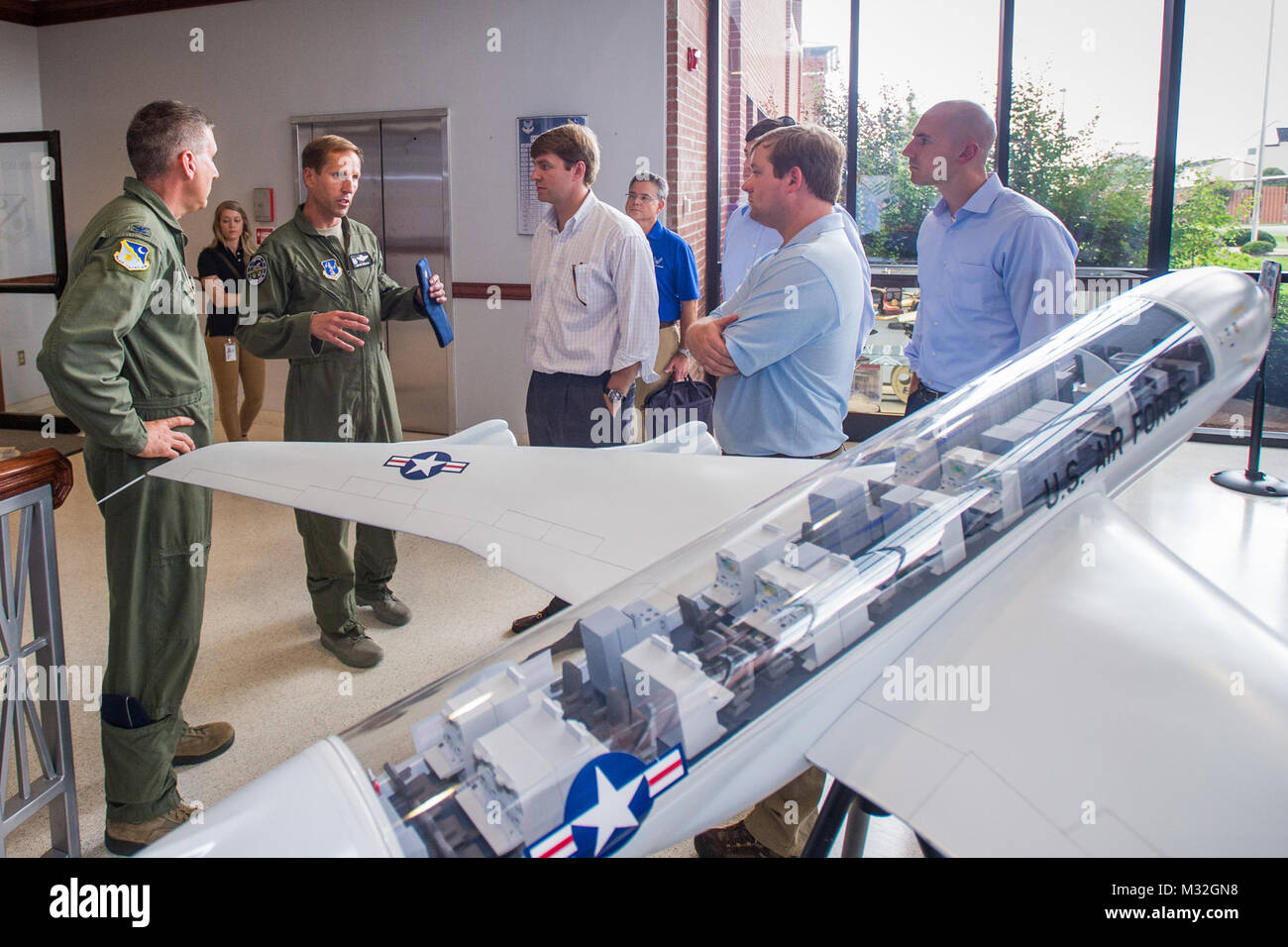 U.S. Air Force Col. John Cooper, left, commander of the 461st Air Control Wing (ACW), and Col. Mark Weber, center speaking, commander of the 116th ACW, Georgia Air National Guard, brief staff delegates from several Georgia congressional and senate offices as they toured Team JSTARS and the E-8C Joint STARS aircraft during a visit to Robins Air Force Base, Ga., Aug. 18, 2015. During the visit, the delegates received a mission briefing updating them on the JSTARS program and an orientation tour of the aircraft. Team JSTARS; consisting of the 116th ACW, Georgia Air National Guard, the 461st ACW a Stock Photo