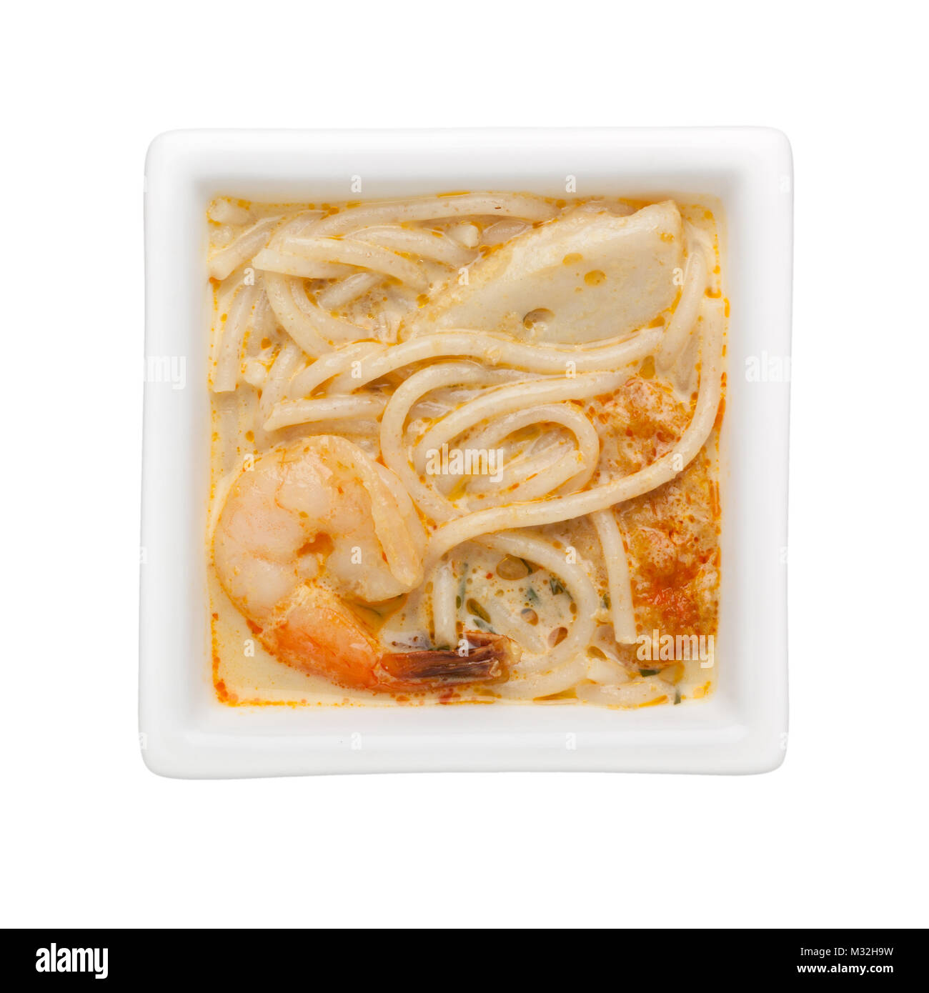 Nonya laksa in a square bowl isolated on white background Stock Photo