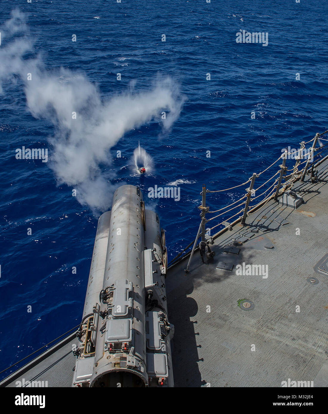 WATERS NEAR GUAM (Mar. 07, 2016) The Arleigh Burke-Class guided-missile destroyer USS McCampbell (DDG-85) fires an MK-54 exercise torpedo (EXTORP) over the port side during an anti-submarine warfare (ASW) event as part of MULTI SAIL 2016. MULTI SAIL is a bilateral training exercise aimed at interoperability between the U.S. and Japanese forces. This exercise builds interoperability and benefits from realistic, shared training, enhancing our ability to work together to confront any contingency. McCampbell is on patrol in the 7th fleet of operations in support of security and stability in the In Stock Photo