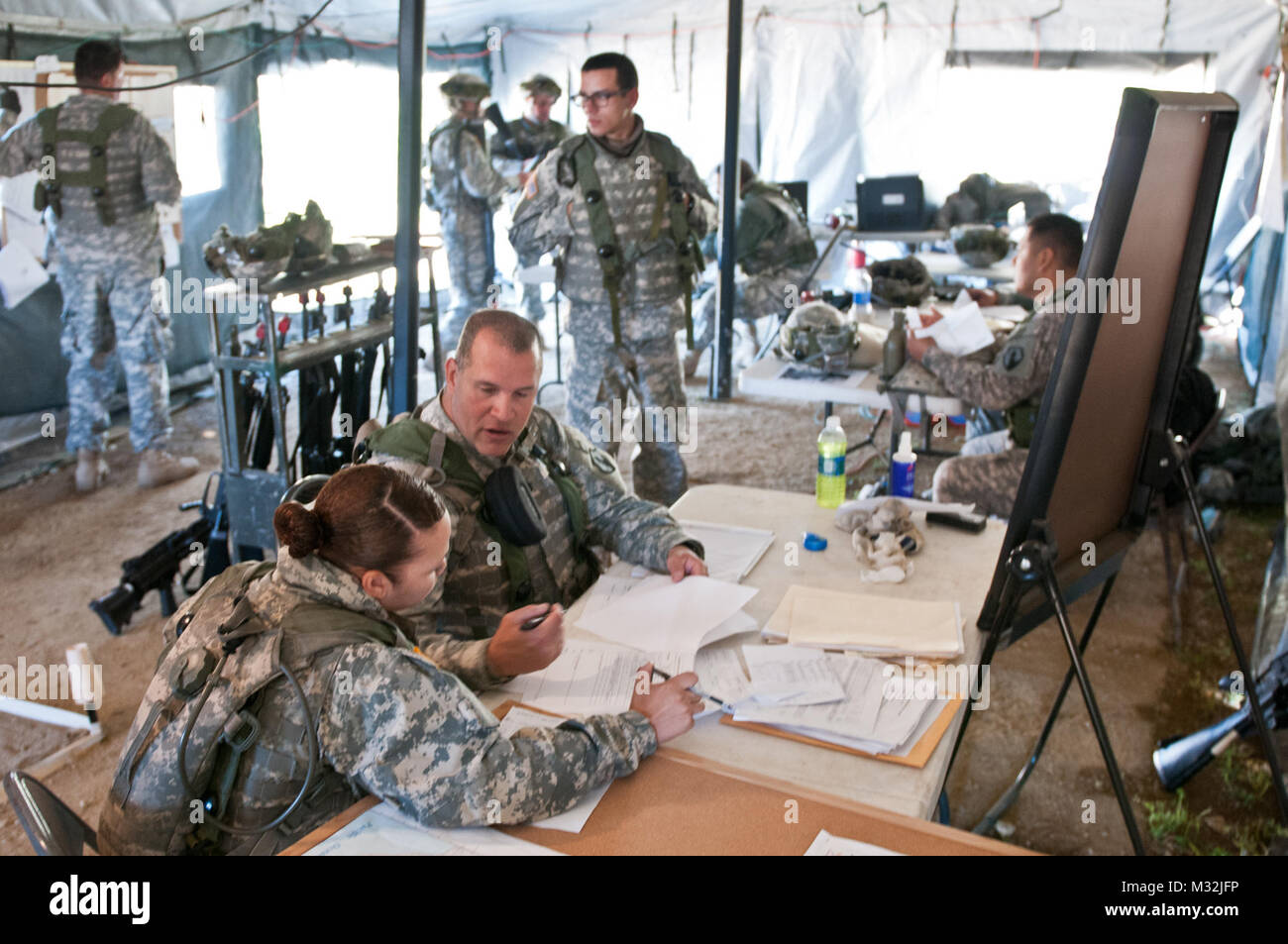 Staff Sgt. Carlos Diaz and Spc. Charlene Suliz, construction engineers with the 475th Engineer Company (Horizontal), an Army Reserve unit from Puerto Rico, review the day's plans during Combat Support Training Exercise 78-16-01 at Fort Hunter Liggett, Cali., March 08, 2016. CSTX 78-16-01 is a U.S. Army Reserve exercise conducted at multiple locations across the country designed to challenge combat support units and Soldiers to improve and sustain skills necessary during a deployment. (U.S. Army photo by Staff Sgt. Dalton Smith/Released) 160308-A-BG398-001 by 316th ESC Stock Photo