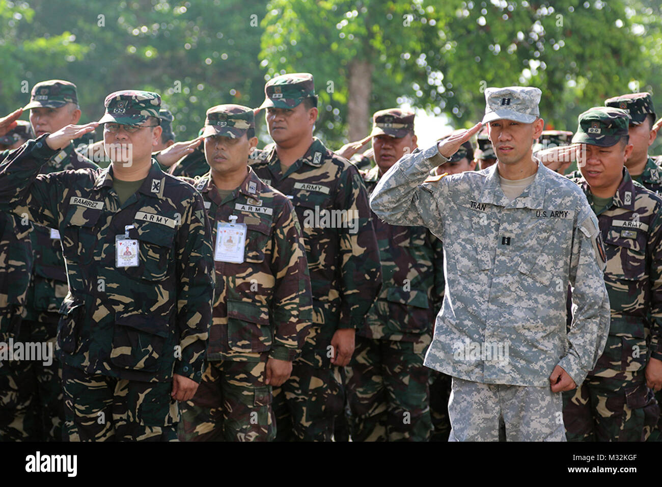 U.S. Army Reserve Cpt. Kevin K. Tran, 303rd Maneuver Enhancement Brigade, operations officer in charge in support of Balikatan 2016 Combined Joint Civil Military Operations Task Force, participates in Armed Forces of the Philippines (AFP) flag raising ceremony at Camp Peralta, Capiz, Philippines, in memory of the historical Bataan Death March of 1942, April 09, 2016. The ceremony was one of many that have brought AFP and U.S. military service members together during the Balikatan Exercise 2016. Balikatan, meaning 'shoulder to shoulder,' is an annual bilateral training exercise that allows for  Stock Photo