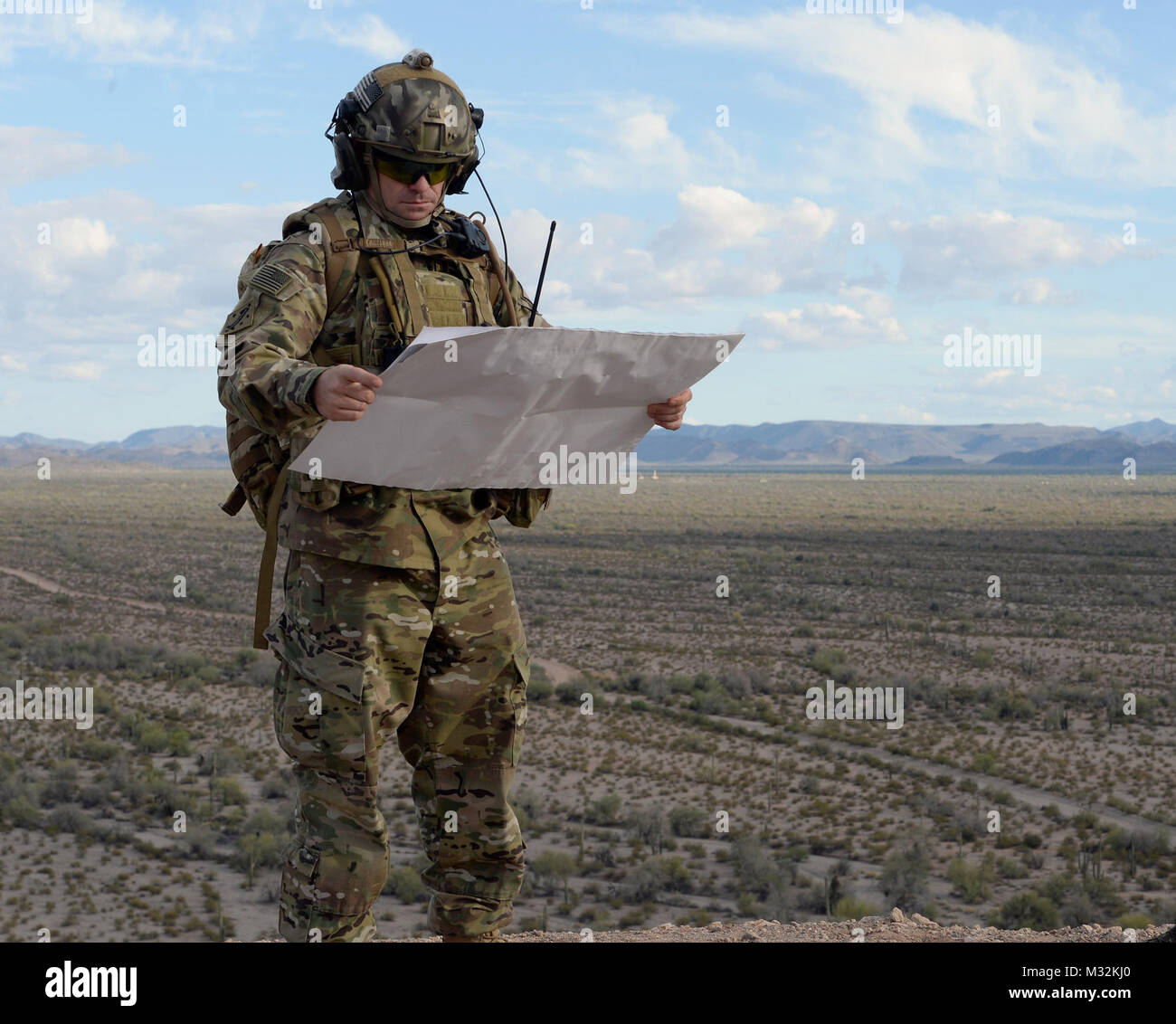 A tactical air control party member with the 147th Air Support Operations Squadron, 147th Reconnaissance Wing, looks at a map during a full mission profile deployment exercise in Gila Bend, Arizona, April 12, 2016. The battlefield airmen traveled to the desert range in Gila Bend for a weeklong simulated deployment with their Czech partners. (U.S. Air National Guard photo by 1st Lt. Alicia Lacy/Released) 160412-Z-NC104-145 by Texas Military Department Stock Photo