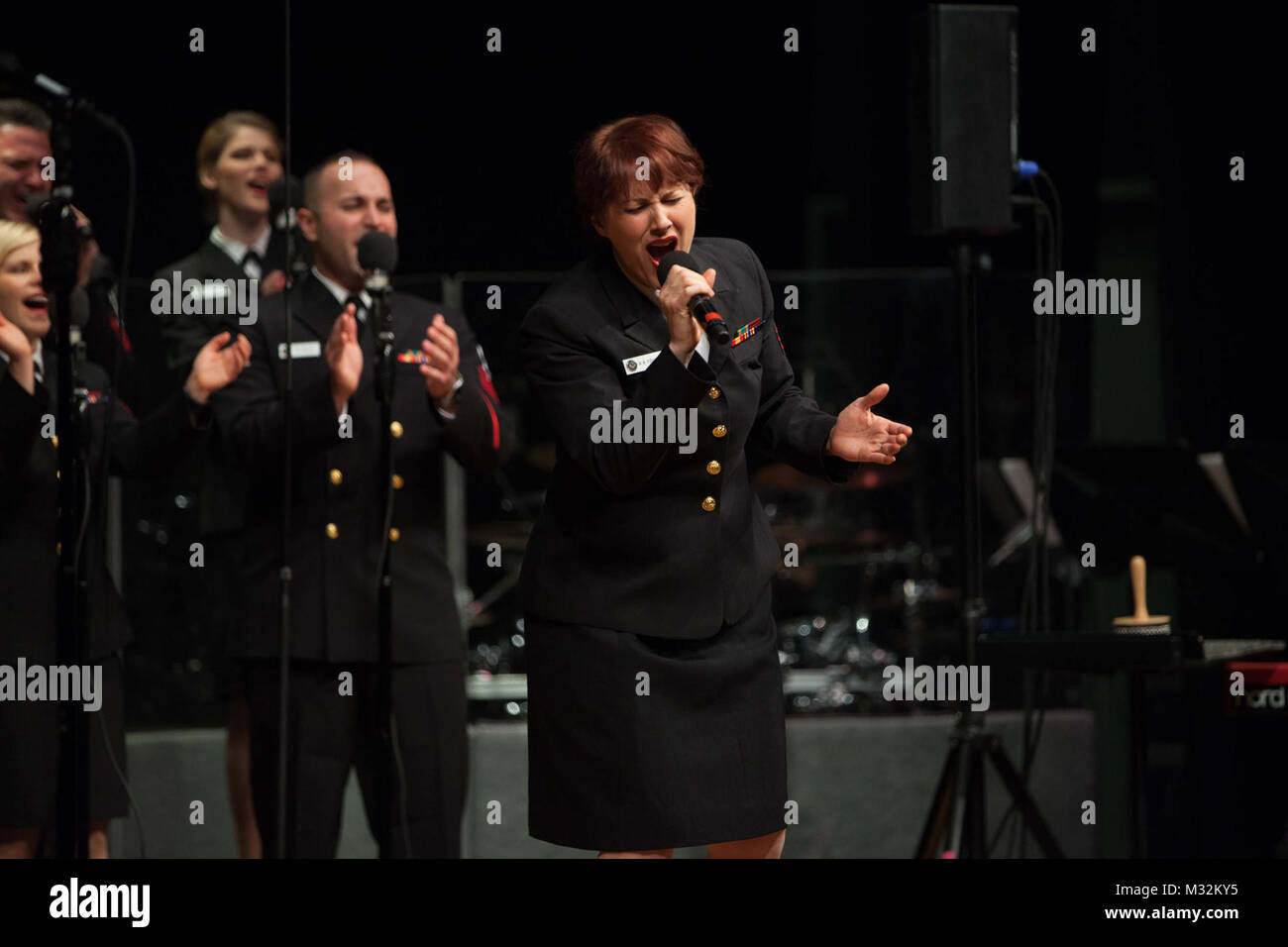 WOBURN, MA (April 18, 2016) Musician 1st Class Maia Rodriguez performs a solo with the United States Navy Band Sea Chanters chorus at a concert at Woburn Memorial High School. The Sea Chanters are on a 22-day tour of the northeastern United States. (U.S. Navy photo by Musician 1st Class Sarah Blecker/Released) 160418-N-WV624-219 by United States Navy Band Stock Photo