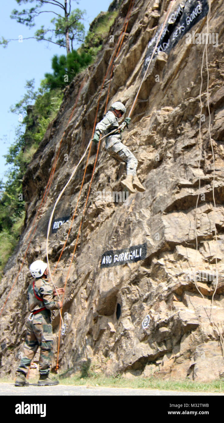A U.S. Soldier from C Troop 5th Squadron, 1st Cavalry Regiment rappels down a rock climbing course as a soldier from the Indian army’s 2nd Battalion, 9th Gurkha Rifles observes during exercise Yudh Abhyas 14 Sept. 20 at Ranikhet Cantonment, Uttarakhand, India. Soldiers from 1st Stryker Brigade Combat Team, 25th Infantry Division and the Indian army are participating in this U.S. Army Pacific-sponsored exercise geared toward enhancing cooperation and coordination through training and cultural exchanges, which help build skills and relationships necessary during a peacekeeping operation. (Photo  Stock Photo