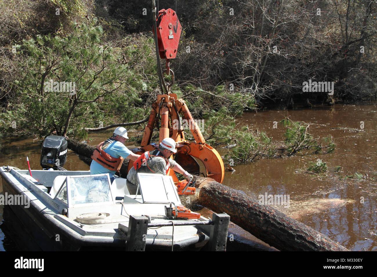 The crew of the U.S. Army Corps of Engineer’s Elizabeth: Richard Bruton, captain, Dennis Barnes, master crane operator, Glen Boykin, marine mechanic, and Eric Sherer, deckhand, have been working all week to clear the Dismal Swamp Canal, after a recent winter storm swept through the area. They said they strongly believe in and practice every day the “t-e-a-m” in teamwork – Together…Earn…Achieve…More.    On March 30, 1929, the U.S. federal government purchased the Dismal Swamp Canal for $500,000, after a protracted period of neglect and general decay by private ownership, worsened by advances in Stock Photo
