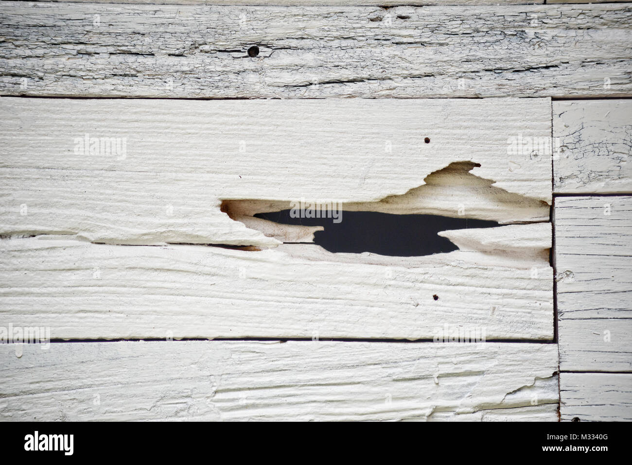 White wooden wall with hole Stock Photo - Alamy