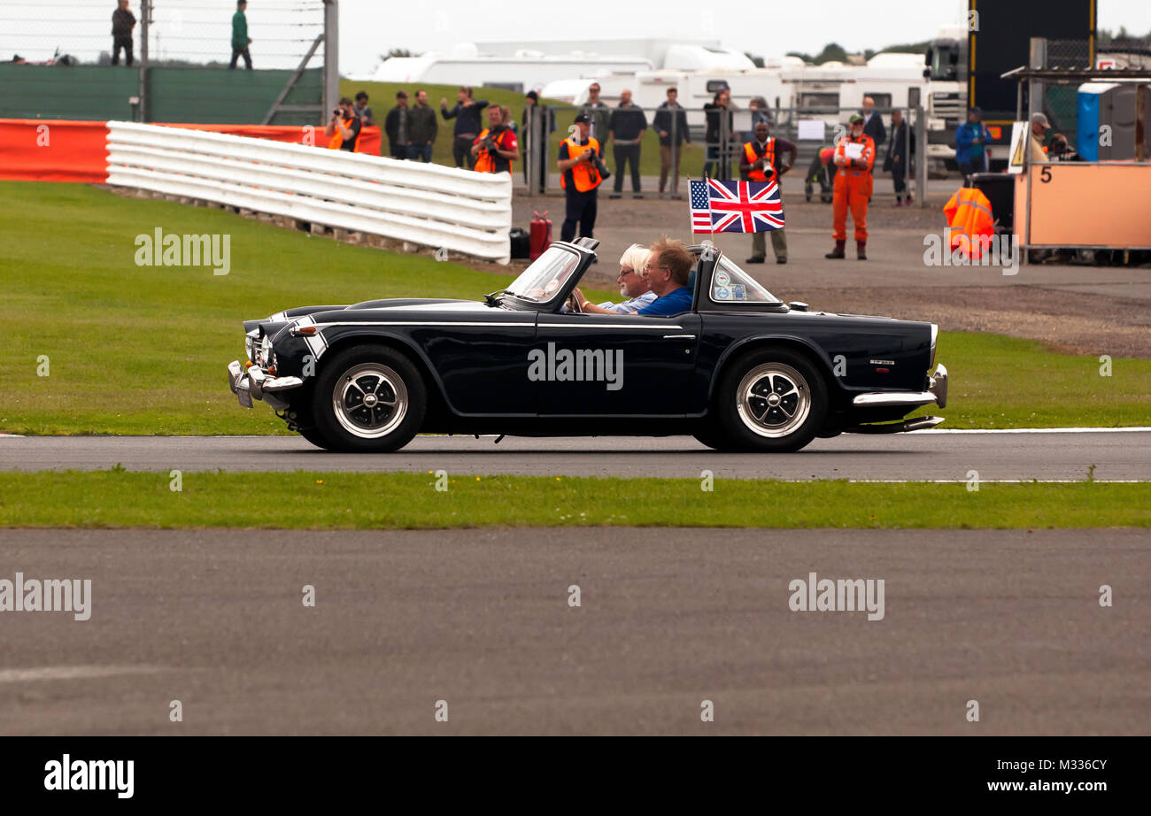 Close-up view of a Triumph TR250 taking part in an anniversary parade around  the circuit, during the 2017 Silverstone Classic Stock Photo