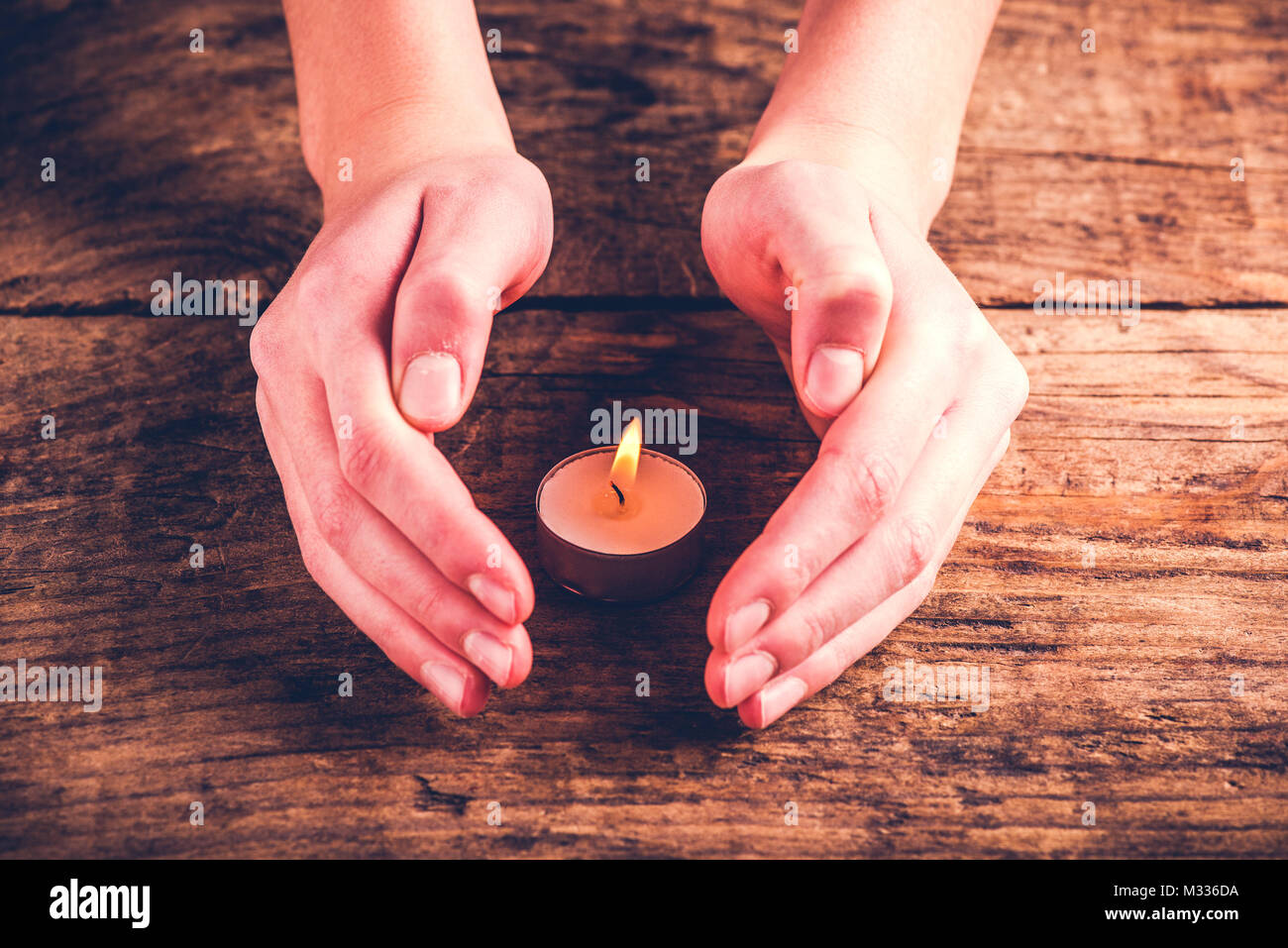 hands protect candle flame protection concept Stock Photo Alamy