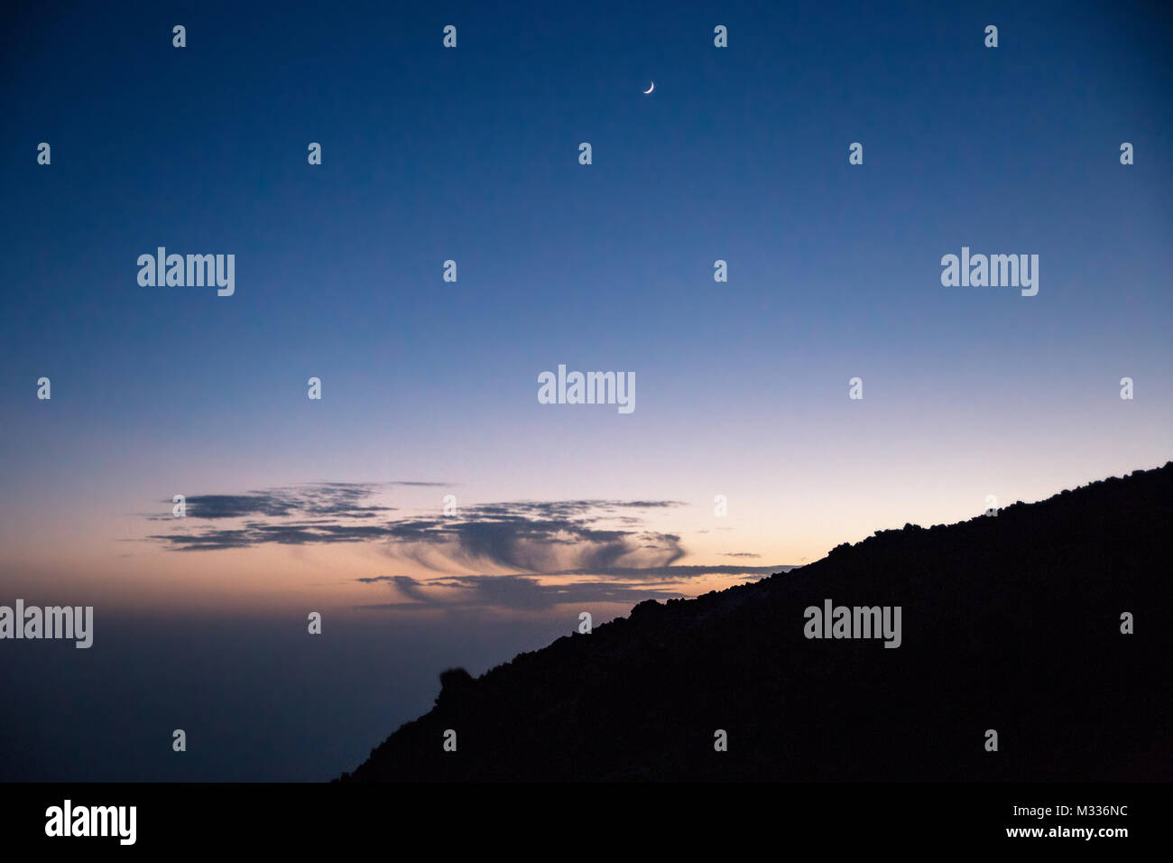 Blue dark night Sky with Shining Moon above Teide Mountain, Tenerife, Spain, Europe Stock Photo