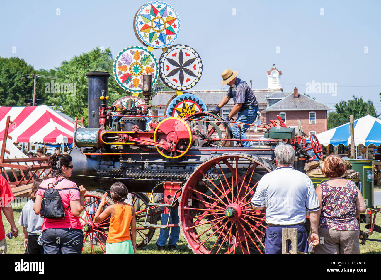 Kutztown Pennsylvania,Kutztown Folk Festival,Pennsylvania Dutch folklife,steam engine tractor,antique,demo,man men male,woman female women,girl girls, Stock Photo