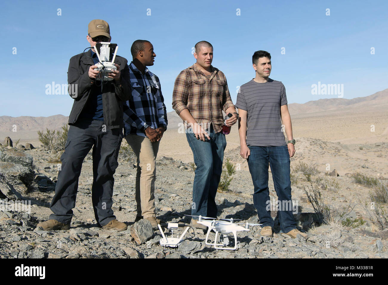 FORT IRWIN, Calif. – Spc. Justin Longshore, Staff Sgt. Jason Lott, Warrant Officer Felipe Tristan, and Spc. Ian Campbell (left to right), assigned to the 782nd Military Intelligence Battalion (Cyber), were involved in the proof concept test of an anti-UAS (unmanned aircraft system) capability as part of the Cyber Electromagnetic Activities (CEMA) Support to Corps and Below (CSCB) program during the 1st Stryker Brigade Combat Team, 4th Infantry Division, National Training Center Rotation 18-03, Jan. 18 to 24. Stock Photo