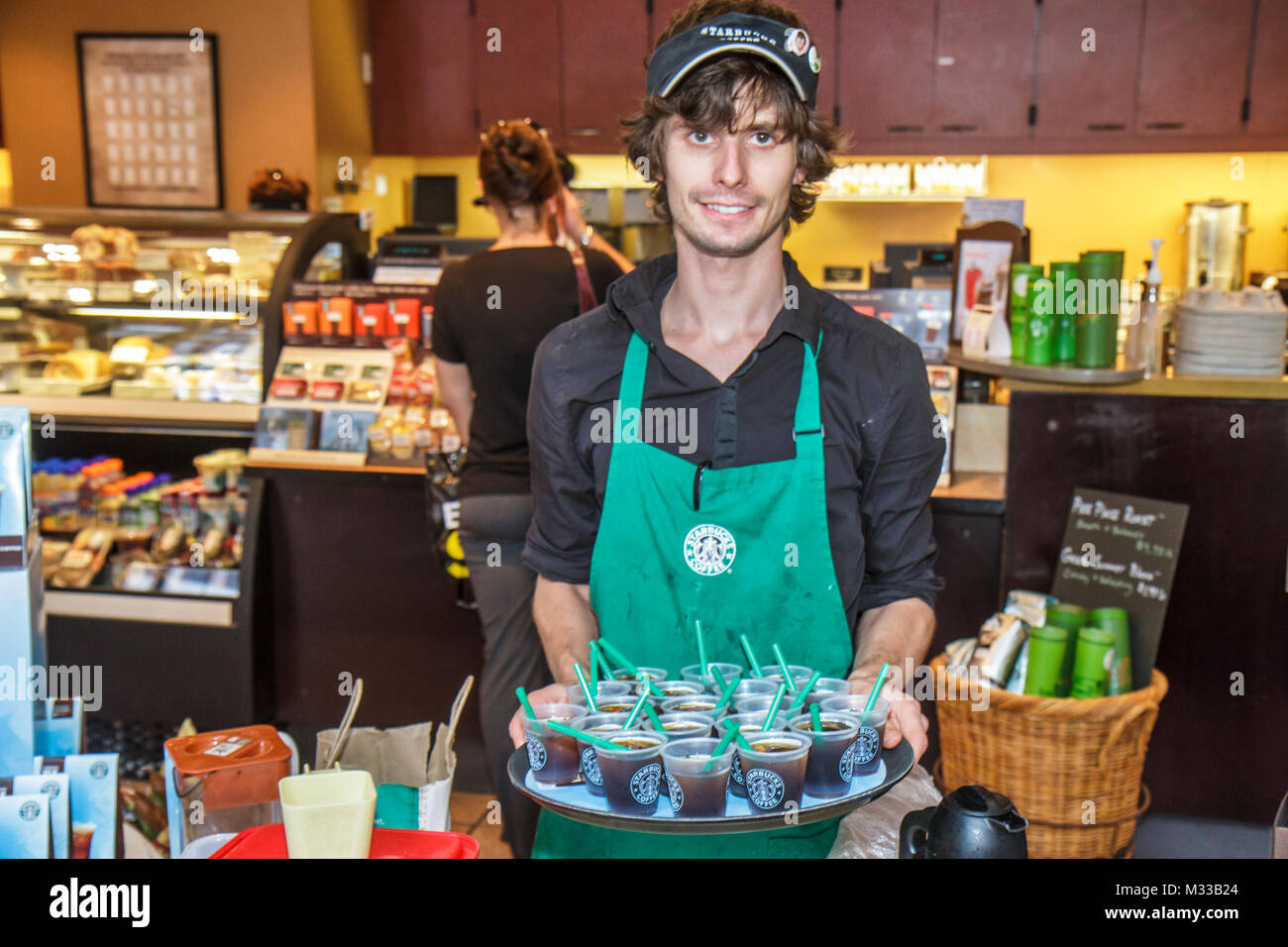Philadelphia Pennsylvania,Market Street,free sample Starbucks Coffee,barista man male,employee worker staff offers offering tray inside interior Stock Photo