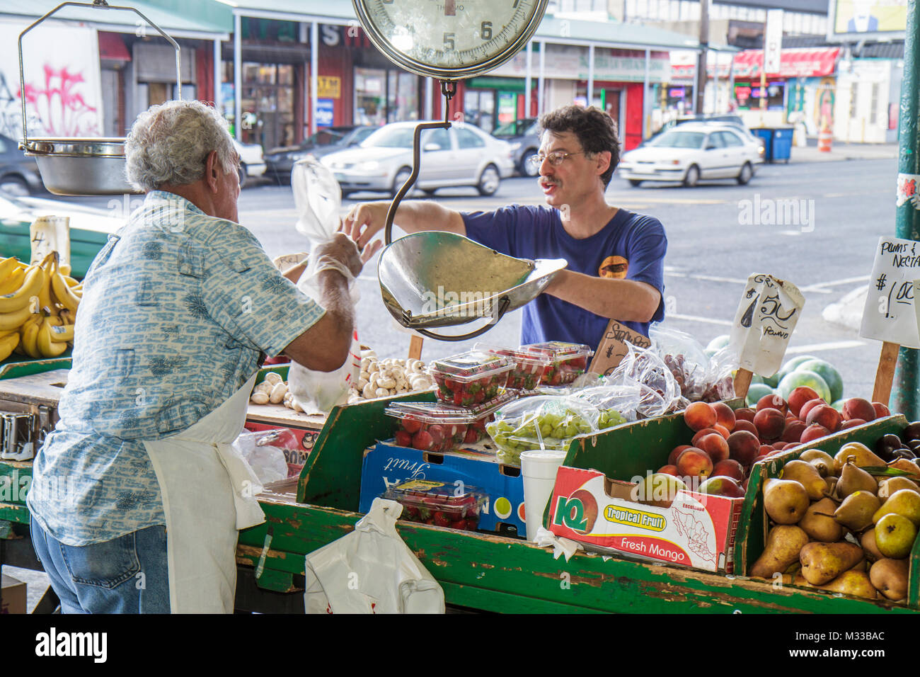 Philadelphia Pennsylvania,South Philly,South 9th Street,Italian Market,immigrant,neighborhood,market,fruit,produce,scale,merchant,pear,grapes,sell,pay Stock Photo