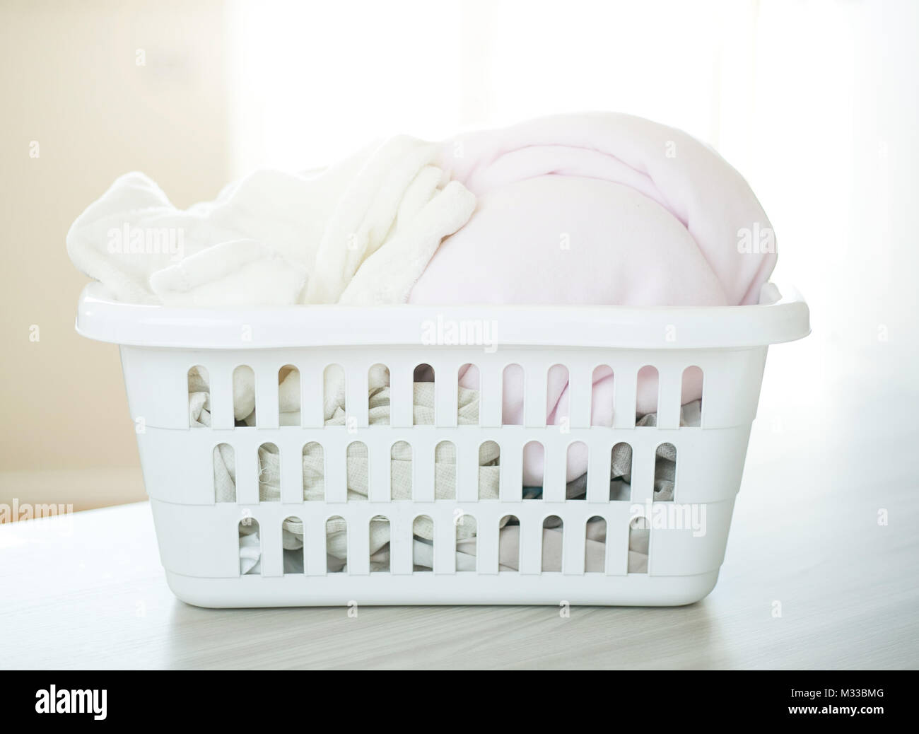 Plastic basket with clean clothes Stock Photo Alamy