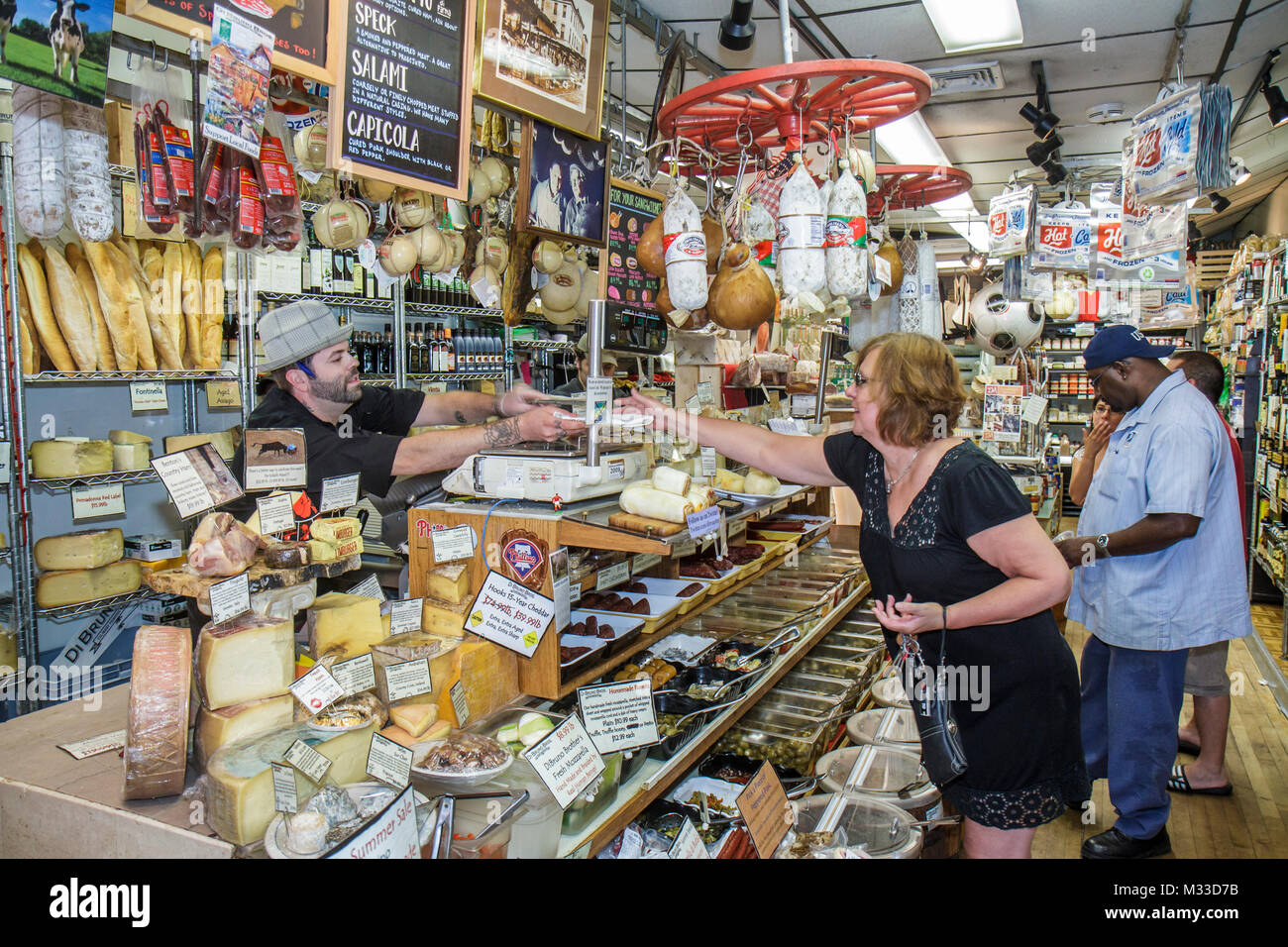 Pennsylvania Philadelphia South Philly South 9th Street,Italian Market imported products DiBruno Brothers,gourmet cheese deli salami olives,woman fema Stock Photo