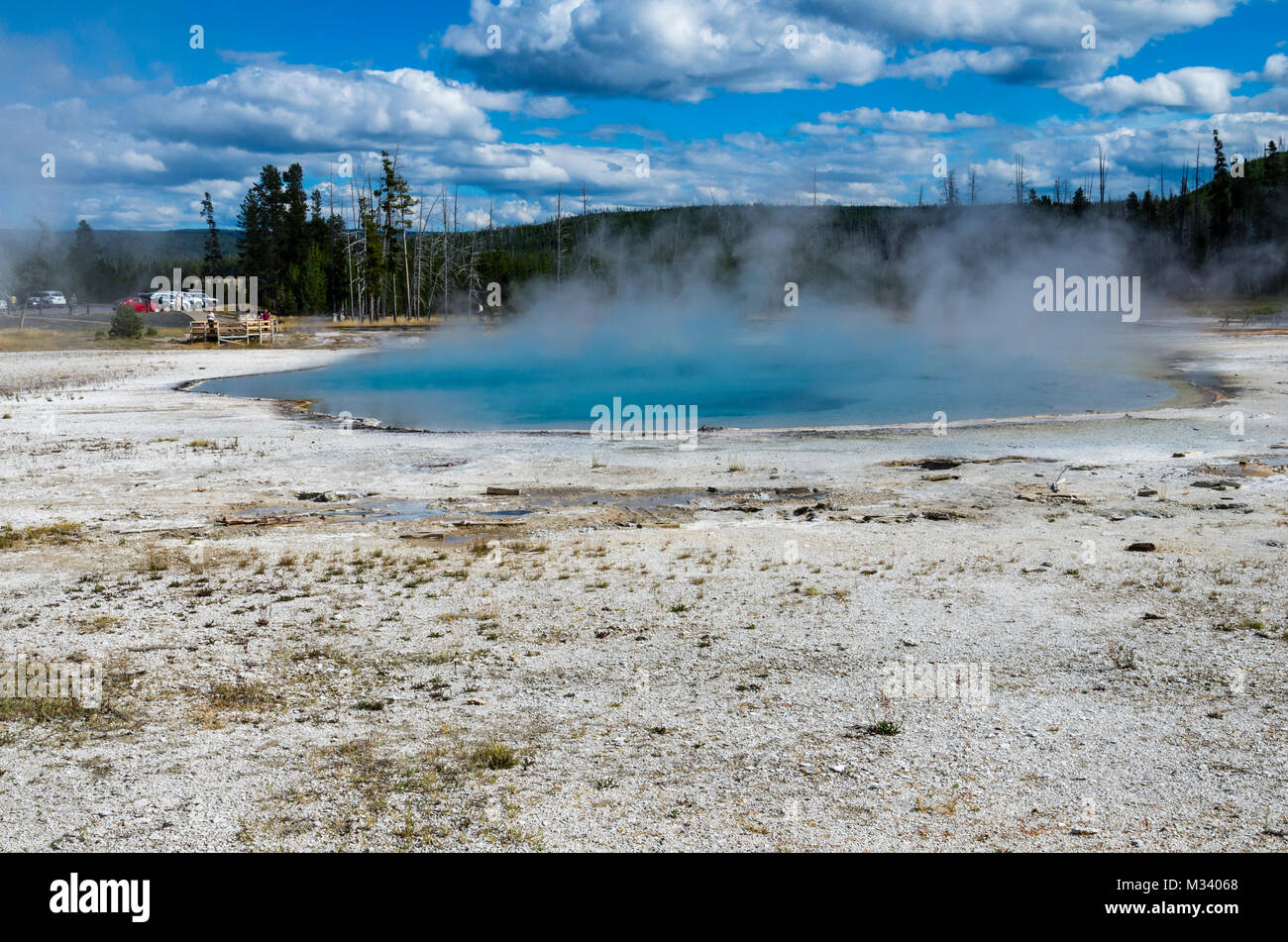 Rainbow Pool in Black Sand Basin with a cloud of steam rising from the surface.  Yellowstone National Park, Wyoming, USA Stock Photo