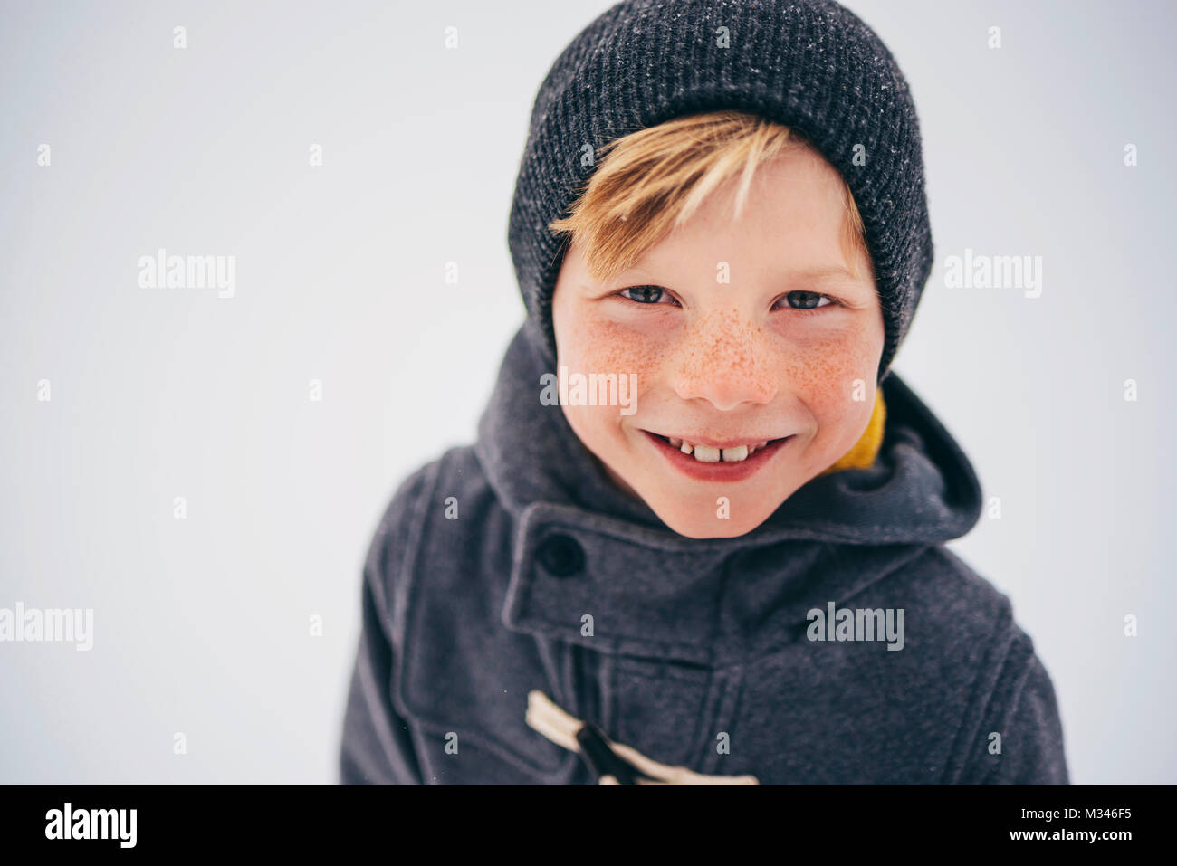 Portrait of a smiling boy holding a Christmas wreath Stock Photo