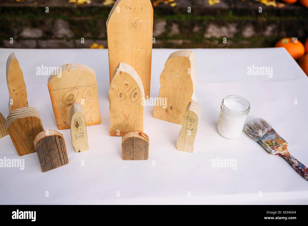 Wooden Ghost decorations for Halloween on a table with white paint Stock Photo