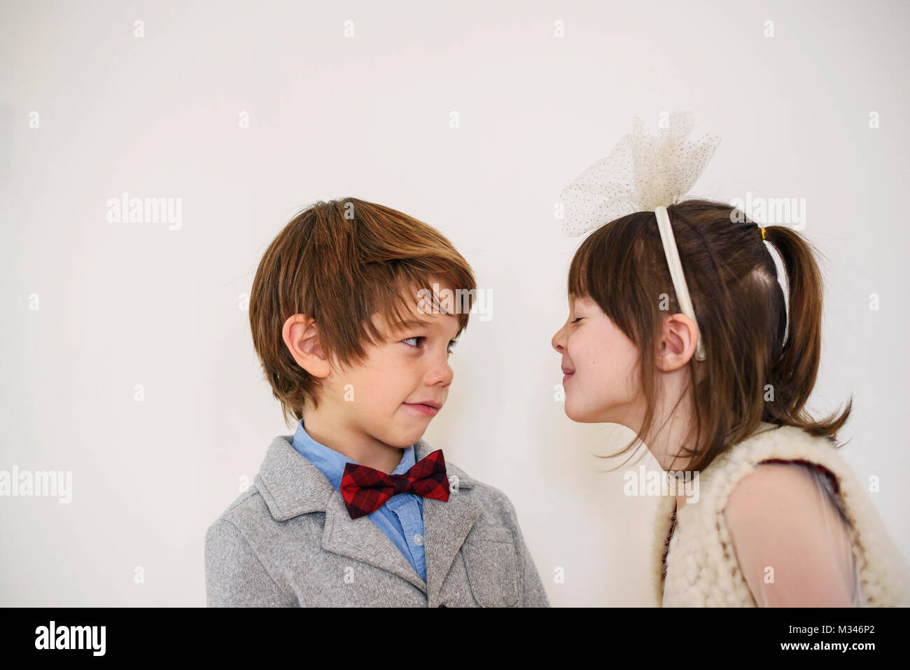 Portrait of a boy and girl looking at each other Stock Photo - Alamy