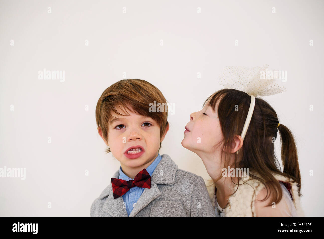 Girl trying to kiss a boy Stock Photo