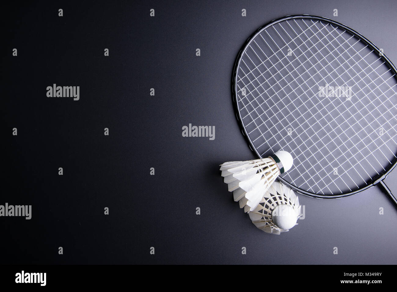 Two shuttlecocks and badminton racket on black background.Sport concept,  Copy space image for your text Stock Photo - Alamy