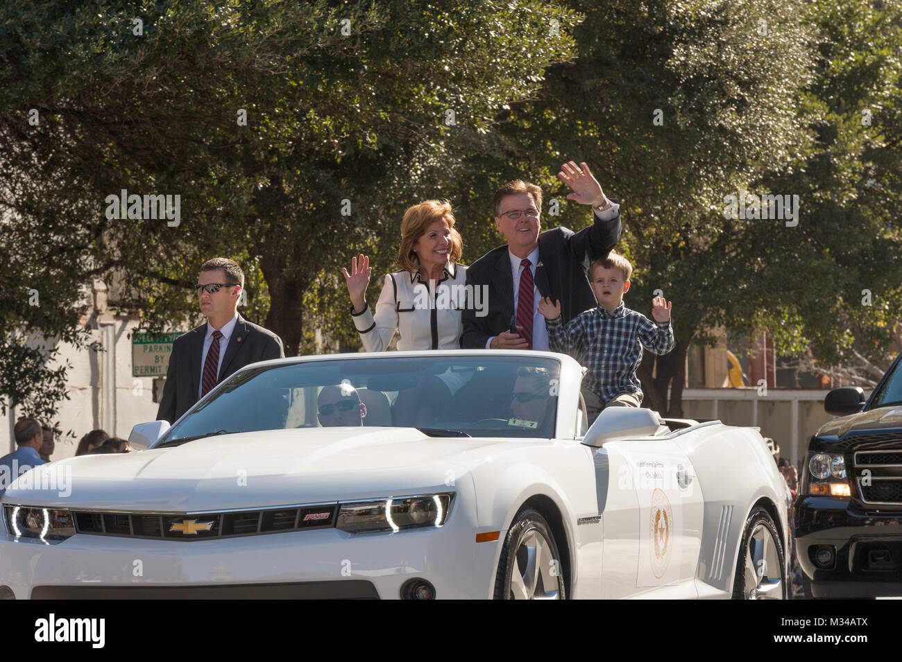 Texas Lt. Governor, Dan Patrick, waves to attendees at the 2015 Texas Gubernatorial Inauguration Parade held in Austin, Texas, Jan. 20, 2015. Service members from the Texas Army, Air and State Guards participated in various roles throughout the event. (U.S. Army National Guard photo by Sgt. 1st Class Malcolm McClendon). Texas National Guardsmen participate in the 2015 Texas Gubernatorial Inauguration by Texas Military Department Stock Photo