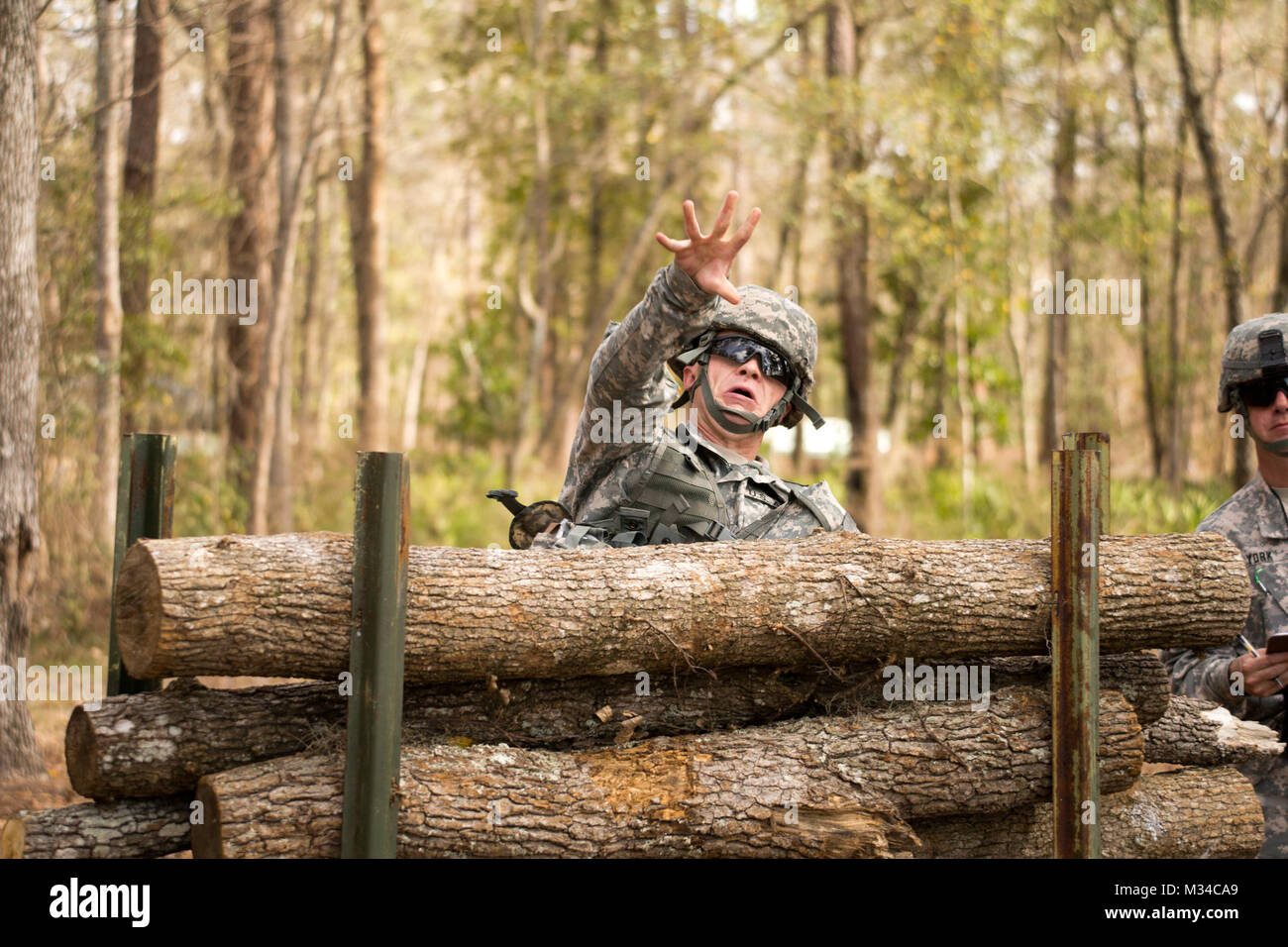 Face off – (GEORGIA GARRISON TRAINING CENTER, Ft. Stewart, Ga. 5 Mar. 2015) - Spc. Caleb DeLong lobs a grenade as part of his defensive movement under direct fire during the Georgia Army National Guard’s 2015 Best Warrior Competition. The competition, held at the Georgia Garrison Training Center at Ft. Stewart, Ga. pits the best military professionals, enlisted and non-commissioned officer, the Georgia Army National Guard has to offer challenging them physically, strategically and written. (Georgia Department of Defense photo by Staff Sgt. Tracy J. Smith | released) Face off by Georgia Natio Stock Photo