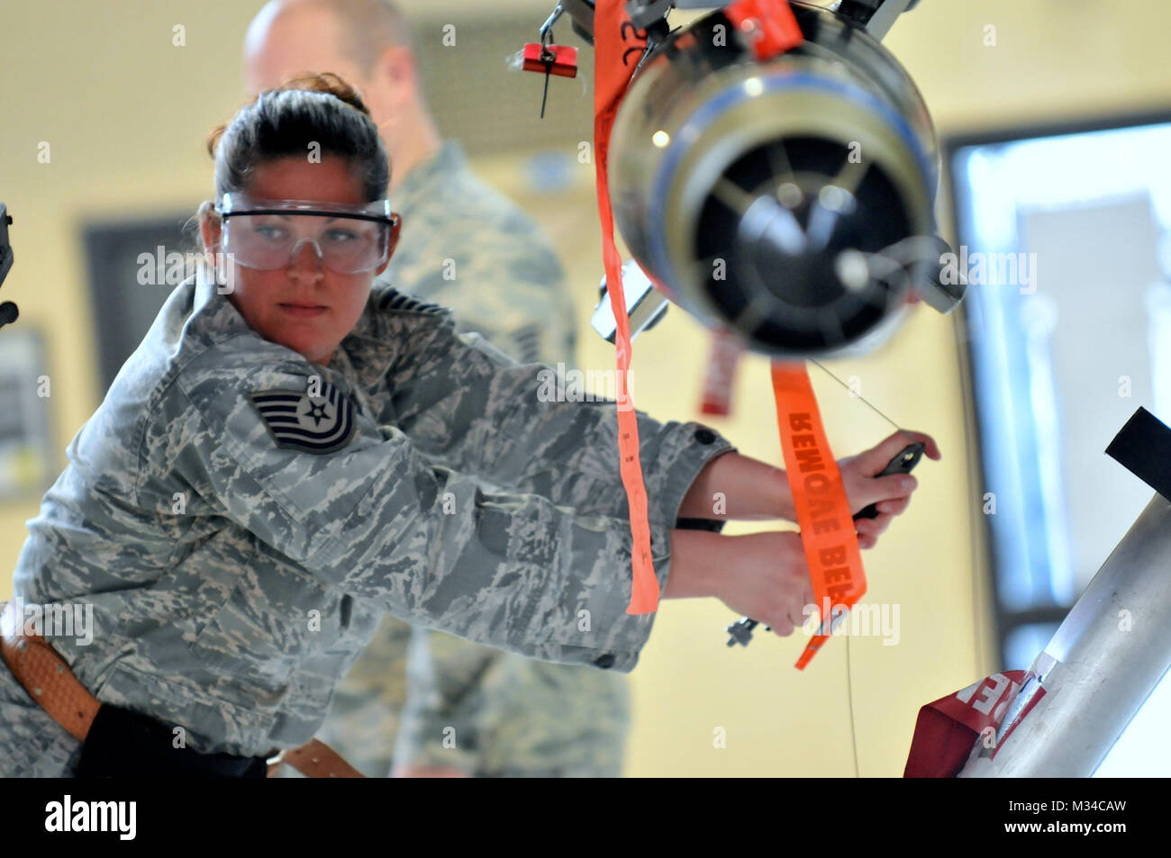 Members of the 174th Attack Wing Munitions Flight train on loading procedures on March 7, 2015, at Hancock Field Air National Guard Base. The munition load crew must be certified quarterly on transporting, loading and wiring munitions onto the MQ-9 Reaper that precisely hit specific targets. The MQ-9 Reaper is an armed, multi-mission, medium-altitude, long-endurance remotely piloted aircraft that is employed primarily for intelligence, surveillance and reconnaissance (ISR). Military intelligence is a military discipline that collects information and analysis to provide guidance and direction t Stock Photo