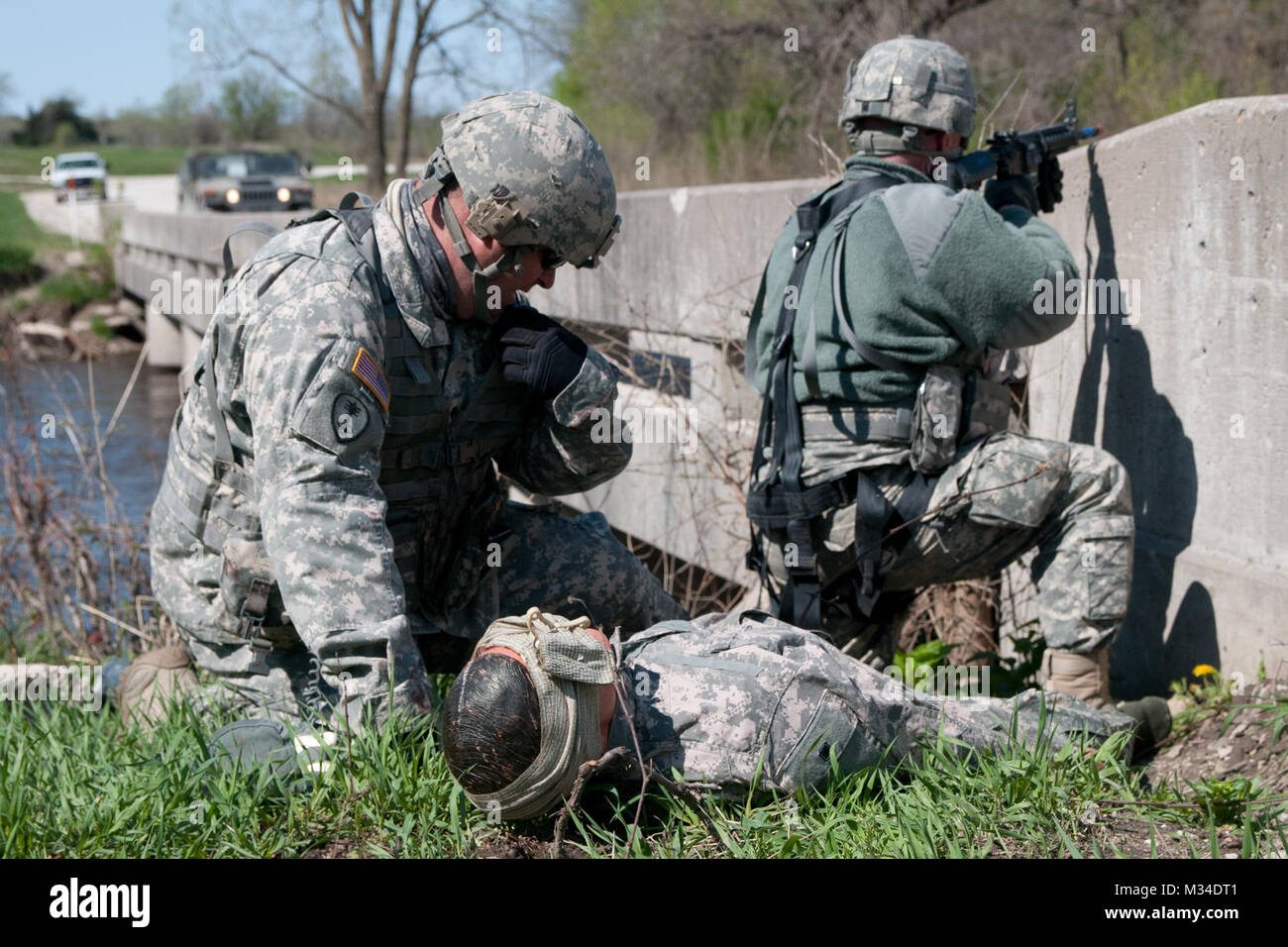 Soldiers from Company A, 700th Brigade Support Battalion, conduct first aid and medical evacuation exercises during their annual training at Camp Dodge, Iowa. The Oklahoma Army National Guard support battalion, headquartered in Norman, Oklahoma, trained from April 13-24, 2015, at the Camp Dodge Sustainment Training Center. The unit's Soldiers strengthened their assigned specialty skills as they trained on every aspect of their combined mission, to include logistical movement, resupply, medical operations and equipment maintenance. (Photo by Spc. Elijah Morlett, 145th Mobile Public Affairs Deta Stock Photo