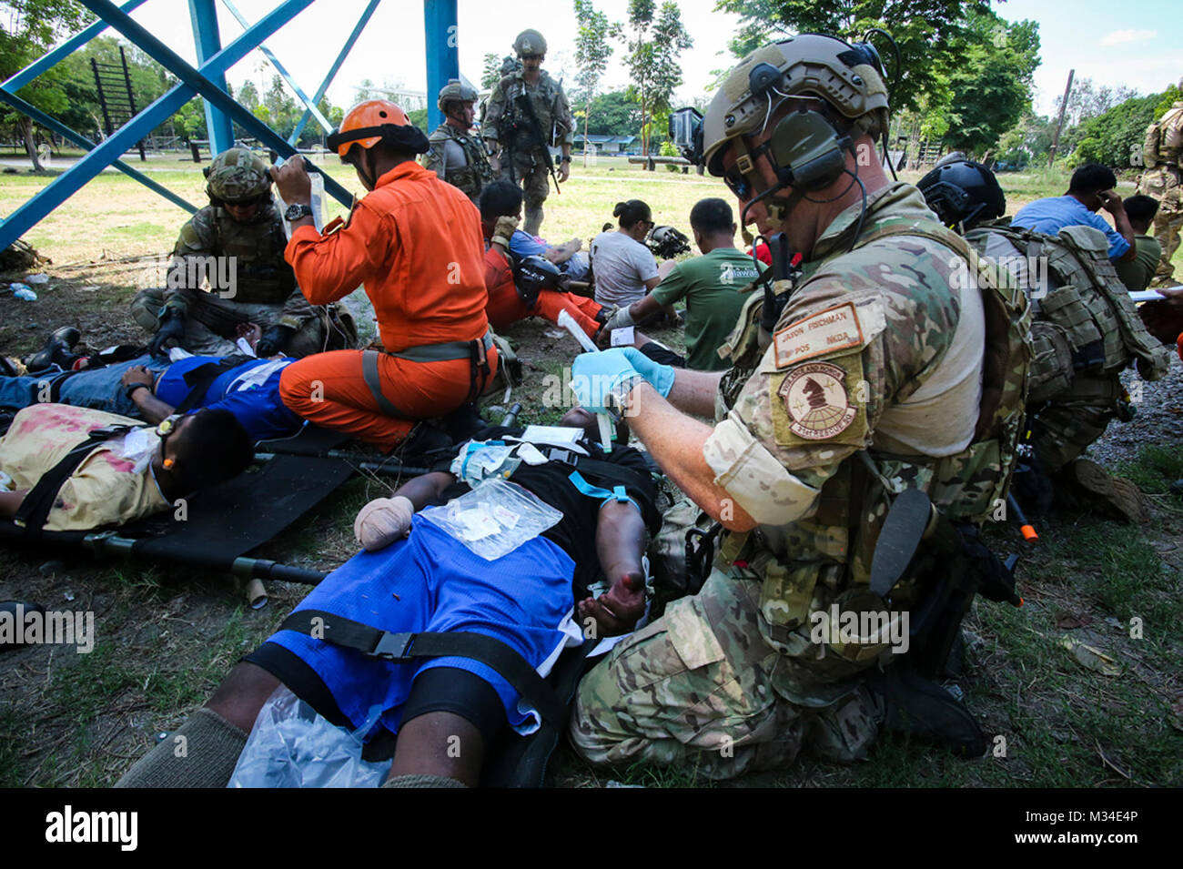 U.S. Air Force Staff Sgt. Jason Fischman, a pararescueman with 31st Rescue Squadron, assists victims of a plane crash as part of a notional mass casualty incident during Exercise Balikatan 2015, in Clark Air Base, Philippines, April 24. The drill was conducted alongside rescuemen from the 505th Rescue and Search Group of the Philippine Air Force. The bilateral training event provided both rescue teams with a better understanding of how each other operates and ensures mission accomplishment should they work side-by-side in the future. Balikatan is an annual Philippines-U.S. military training ex Stock Photo